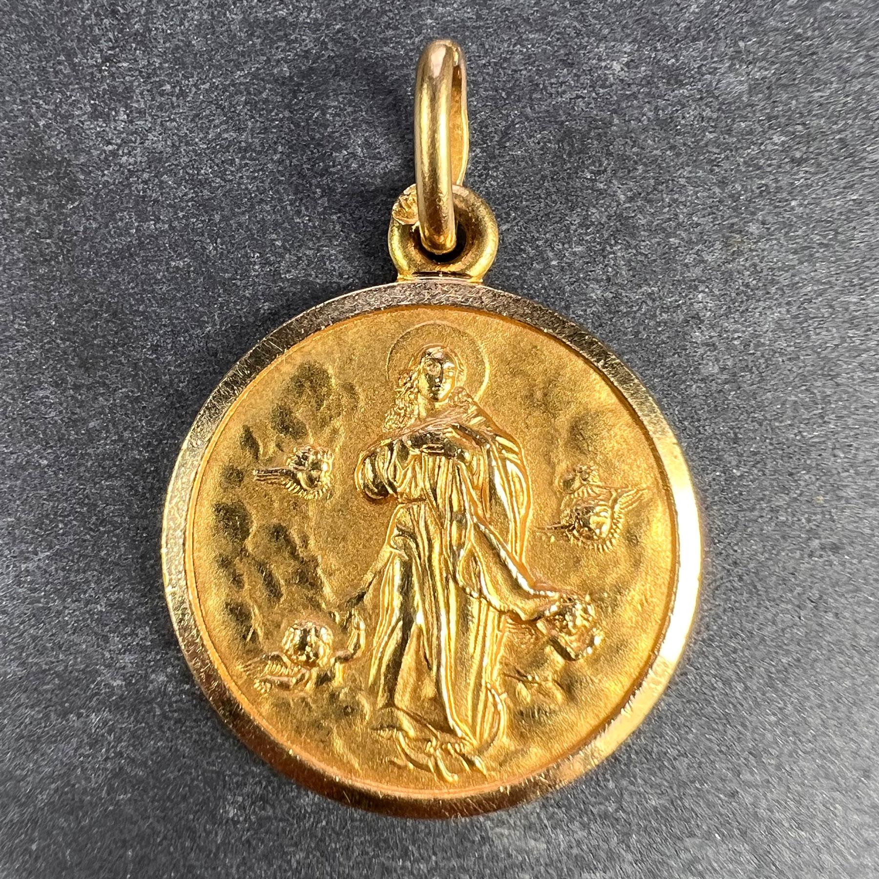 An Italian 18 karat (18K) yellow gold charm pendant designed as a medal depicting the Virgin Mary in Heaven surrounded by putti. Stamped 750 for 18 karat gold and Italian manufacture and marked 1AR and UNO AR to the jump ring for Gori &