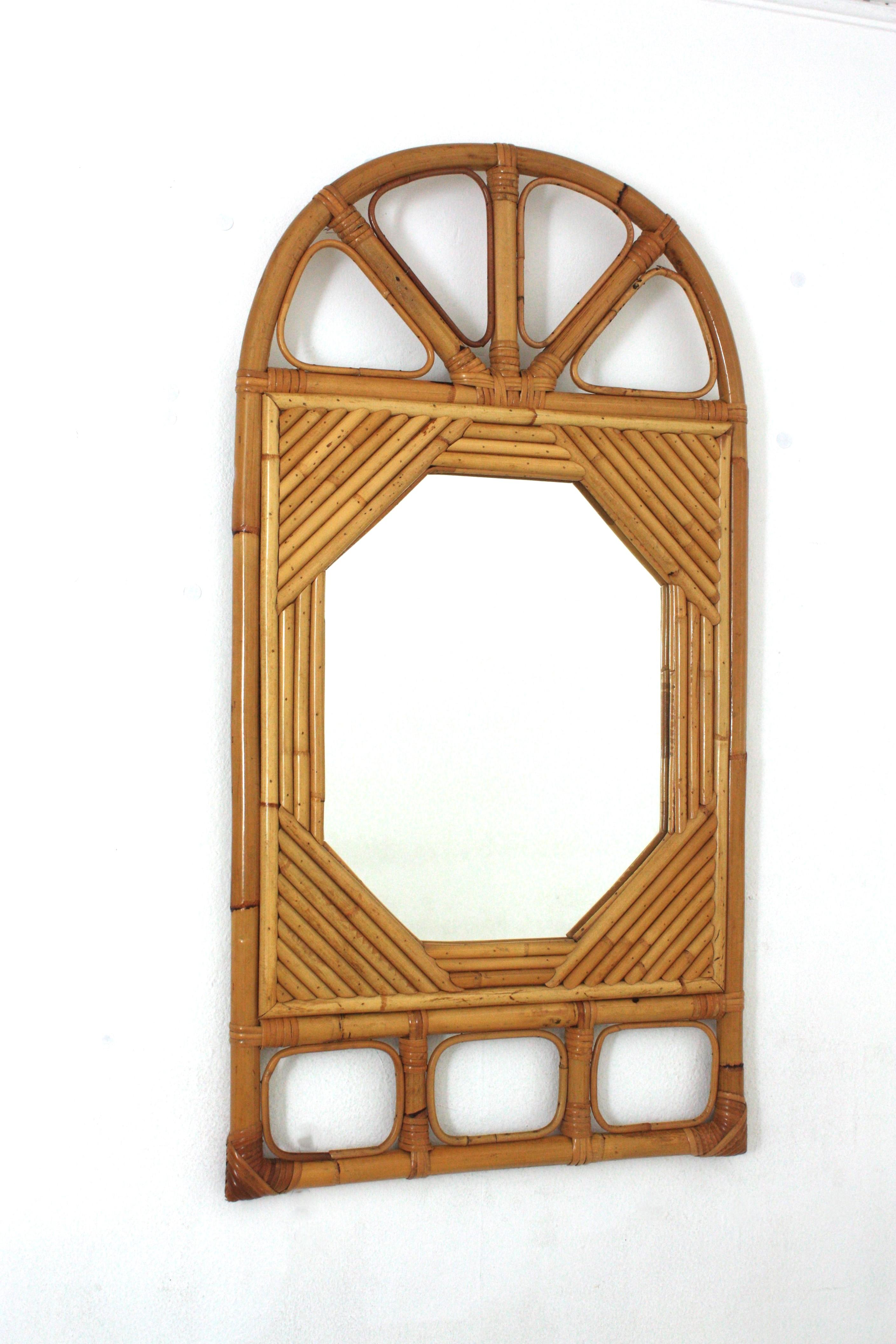Eye-catching Midcentury  split reed rattan mirror with arched top. Italy, 1960s
Attributed to Vivai del Sud
This beautiful mirror was handcrafted with bamboo cane and rattan combining midcentury and orientalist accents.
A bamboo and rattan frame