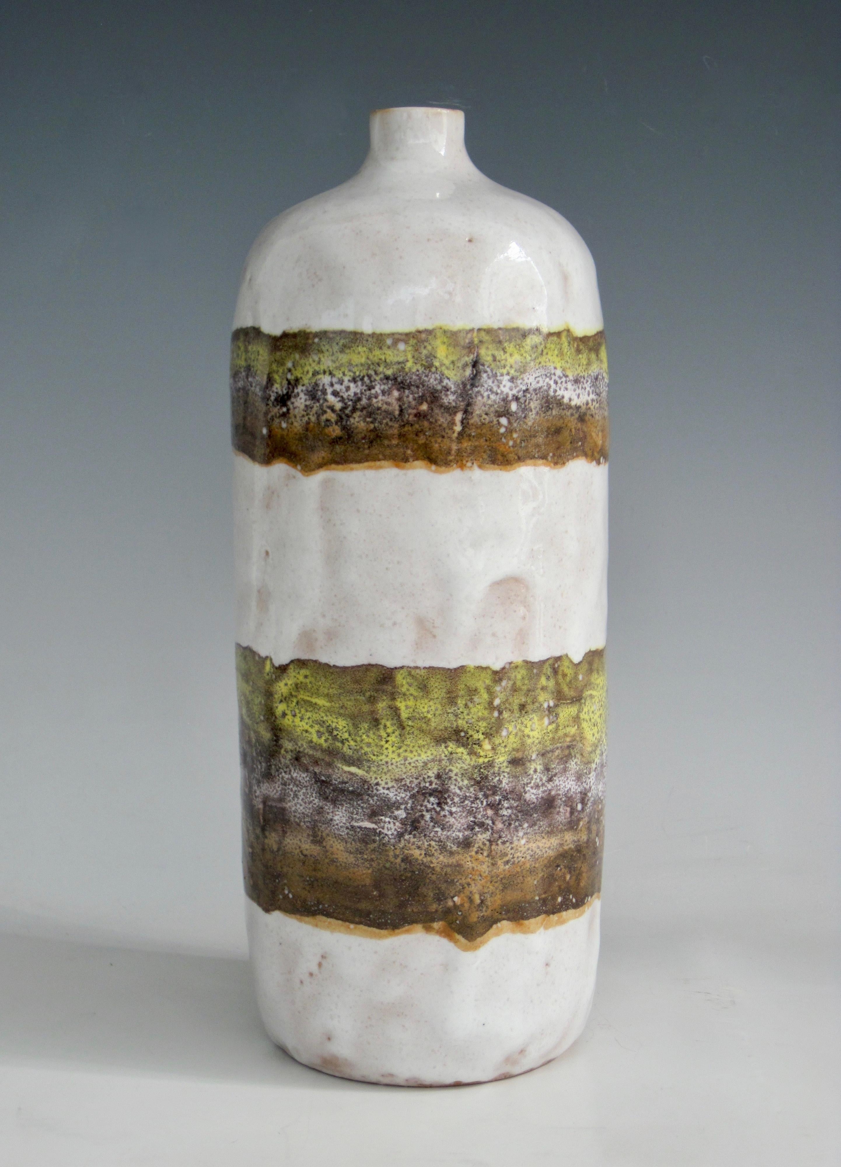 1960s Italian bottleneck vase with a semi translucent bubbly milky white glaze and horizontal bands of volcanic glaze in lavender, yellow and burnished rust. 
We appreciate the 'lemon glaze' look and contrasting textures.
Imported by Raymor.
Signed