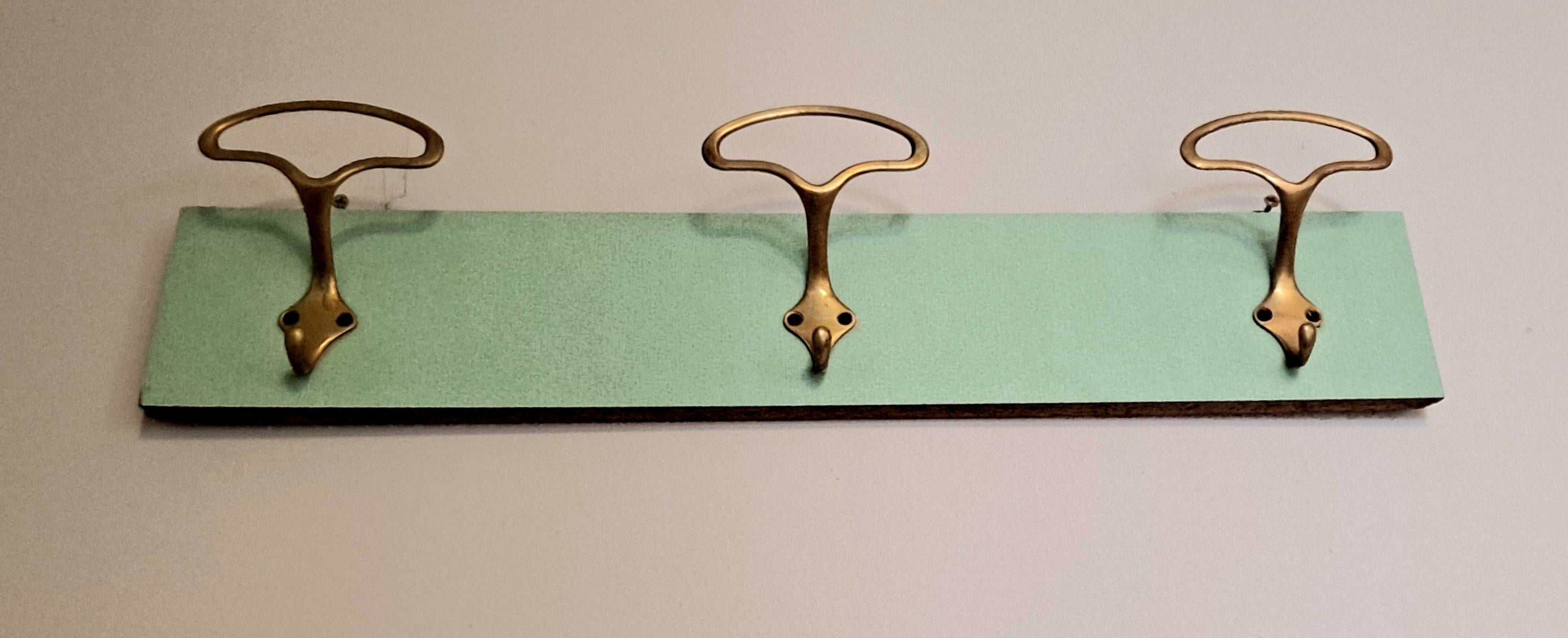 wall hanger on the original 1950s Formica . Brass hooks .