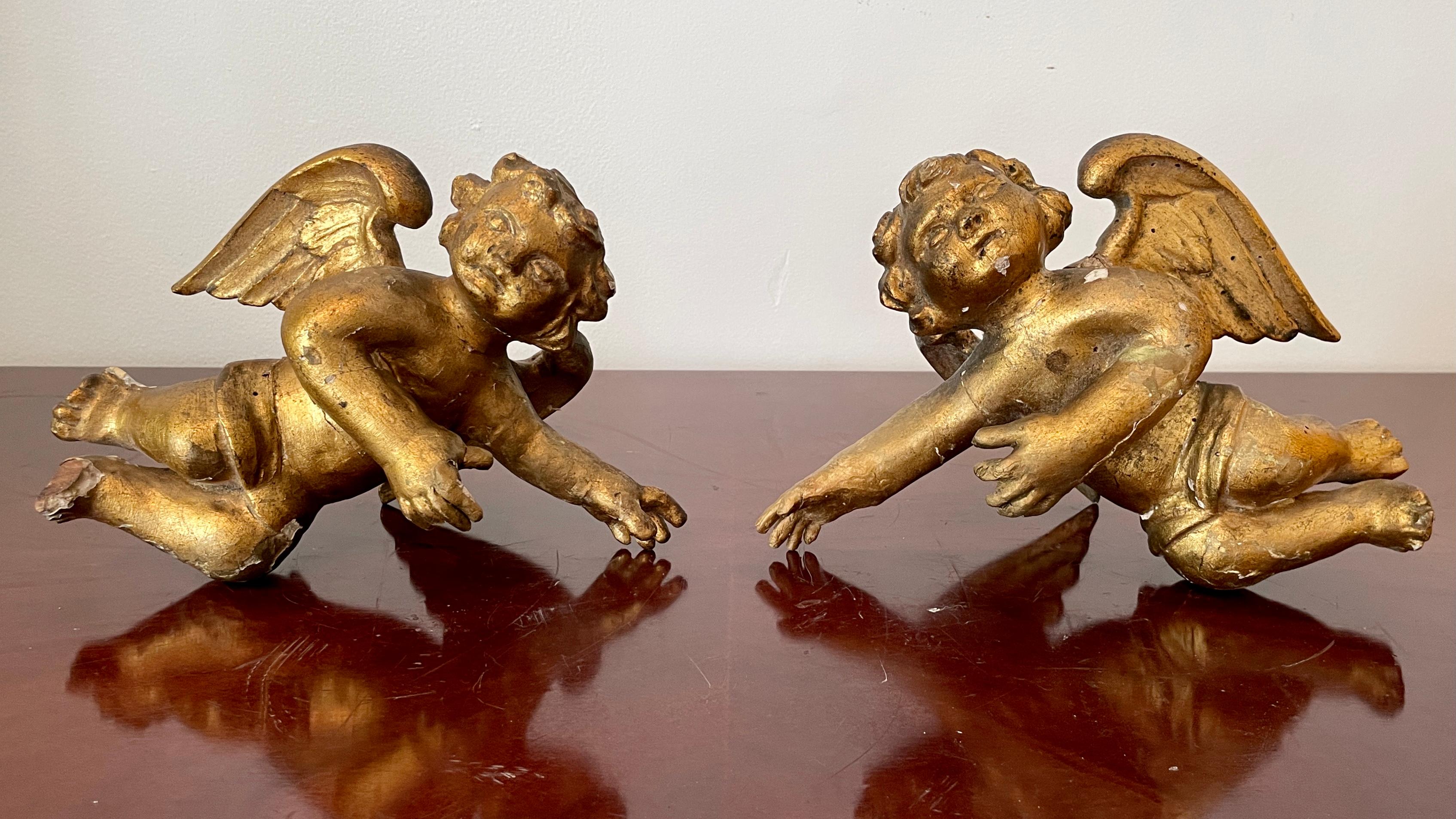 Classic vintage pair of Italian wall hanging Cherubs carved from wood. These items preserve their original gold paint.
