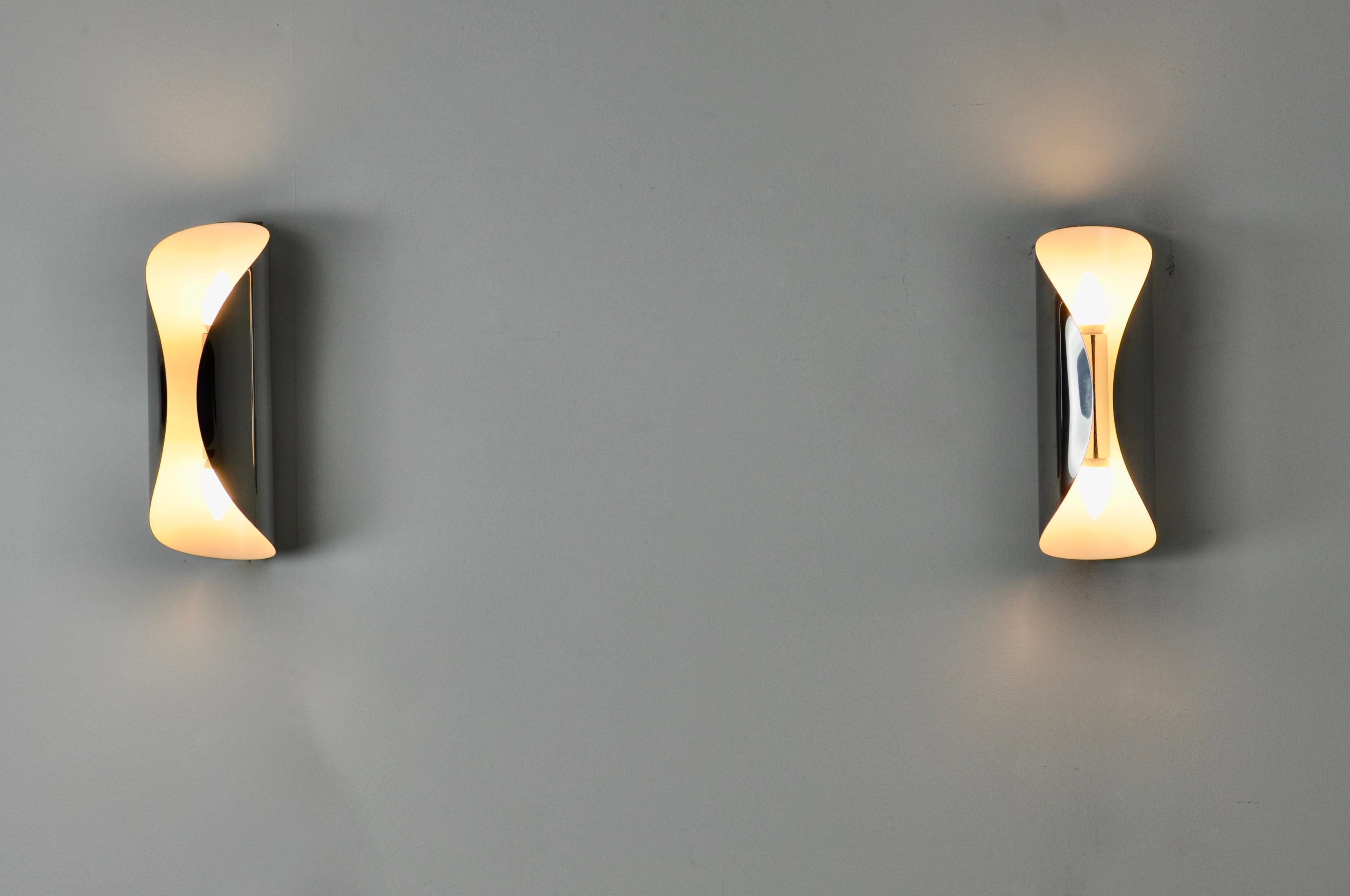 Pair of chrome plated metal sconces. 2 points of light. Wear and tear due to time and age of sconces.