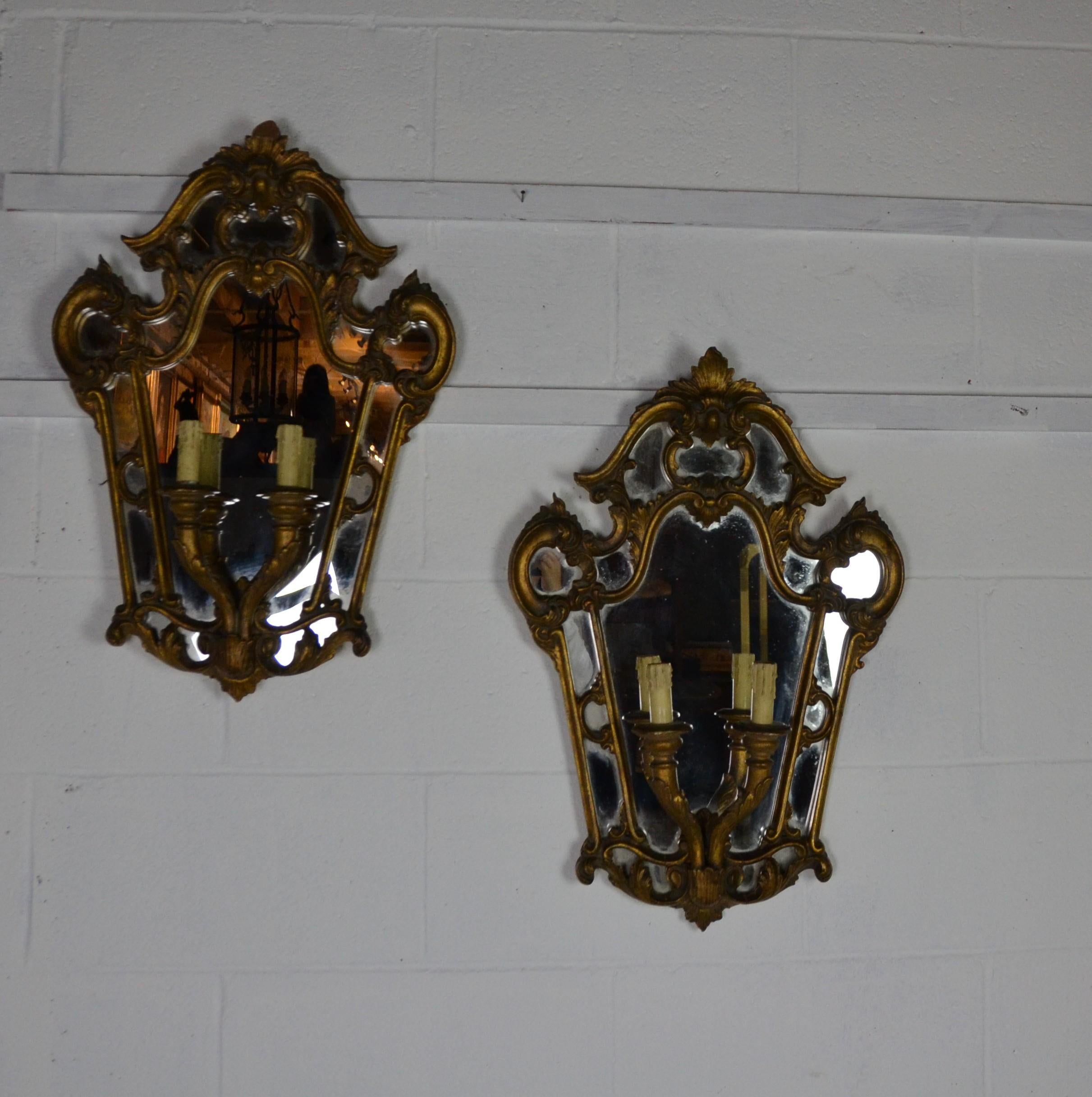 Pair of mirrored back wall light fixture. Wired for the USA.