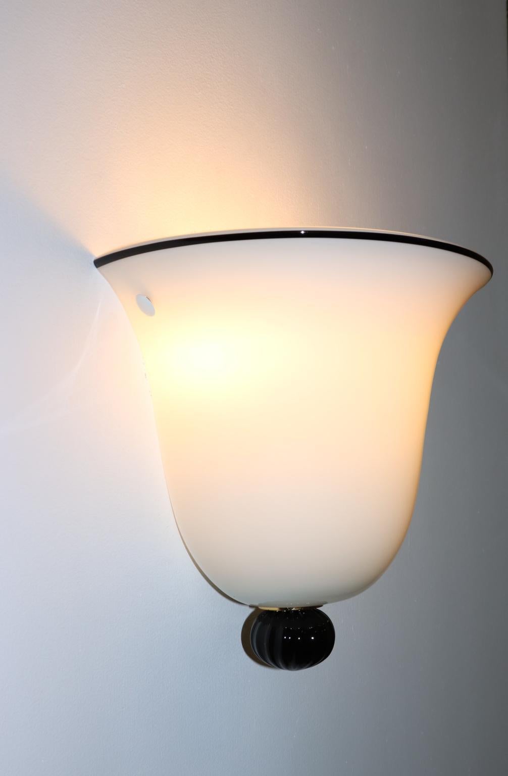 Italian wall light milky white Murano hand blown glass with black border and ball. Manufactured by Murano Due.
Design from 