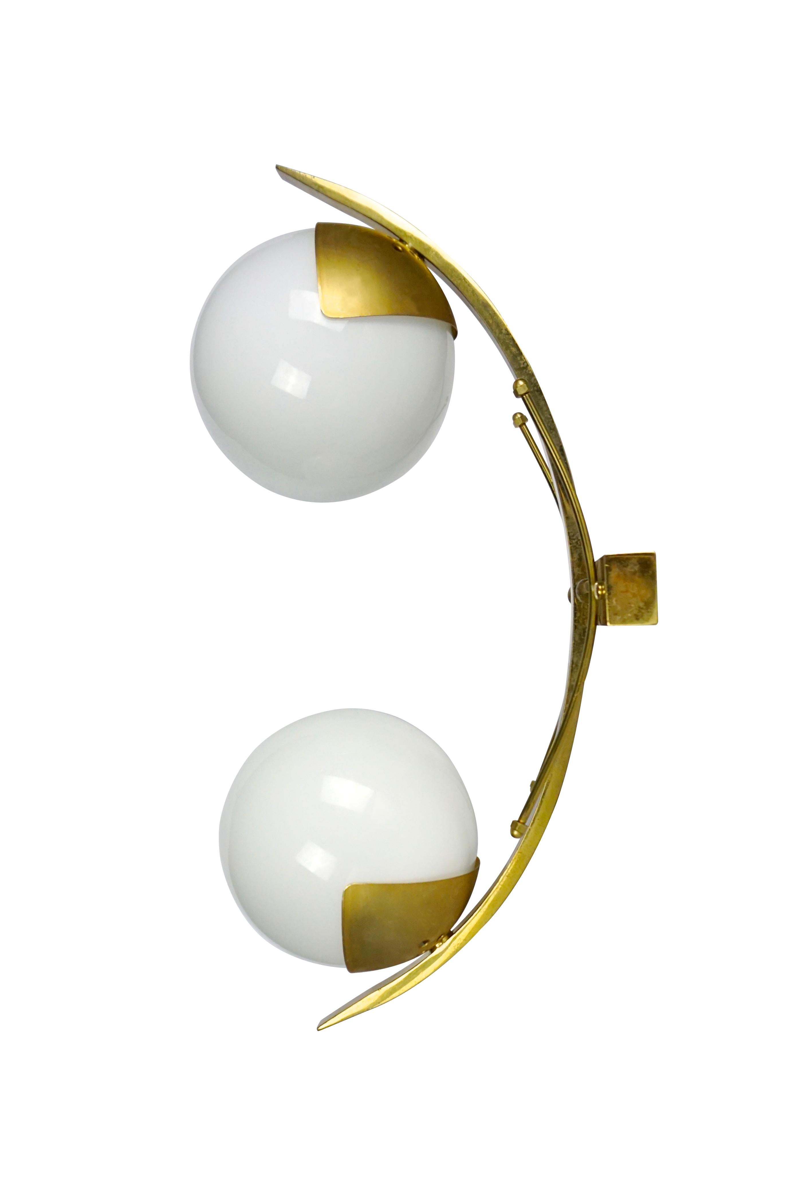 Elegant pair of wall lights or sconces each holding two opaline glass globe shades and brass frame, circa 1960's.
-Made in Italy
-Dimensions: H 42 x W 15 x D 23 cm.