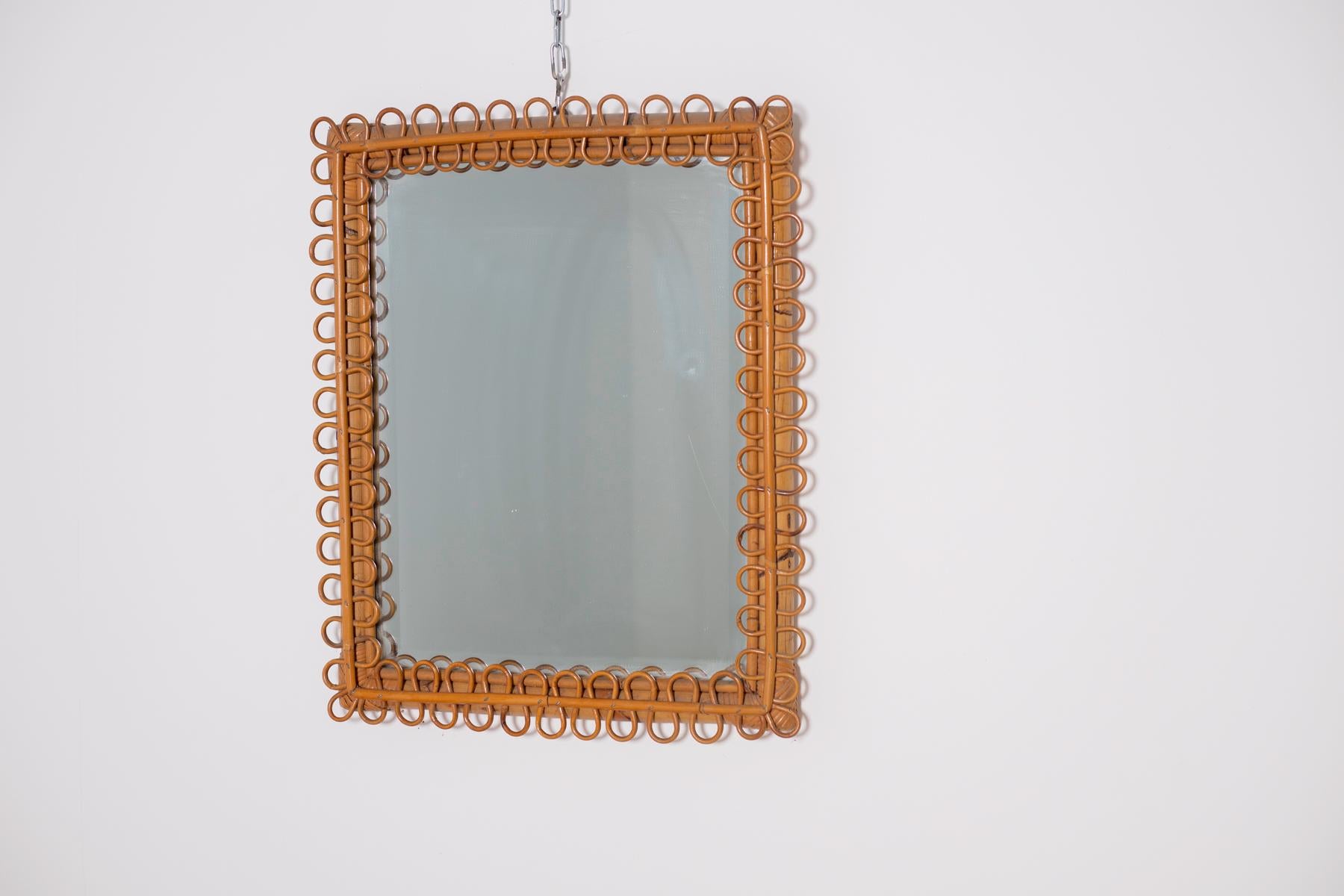 Beautiful Italian mirror from the midcentury, 1950s. The mirror is in perfect vintage condition. Made entirely of bamboo it recalls a jungle and safari style. Its particularity is its bamboo frame made in torchon. The mirror is ideal for safari