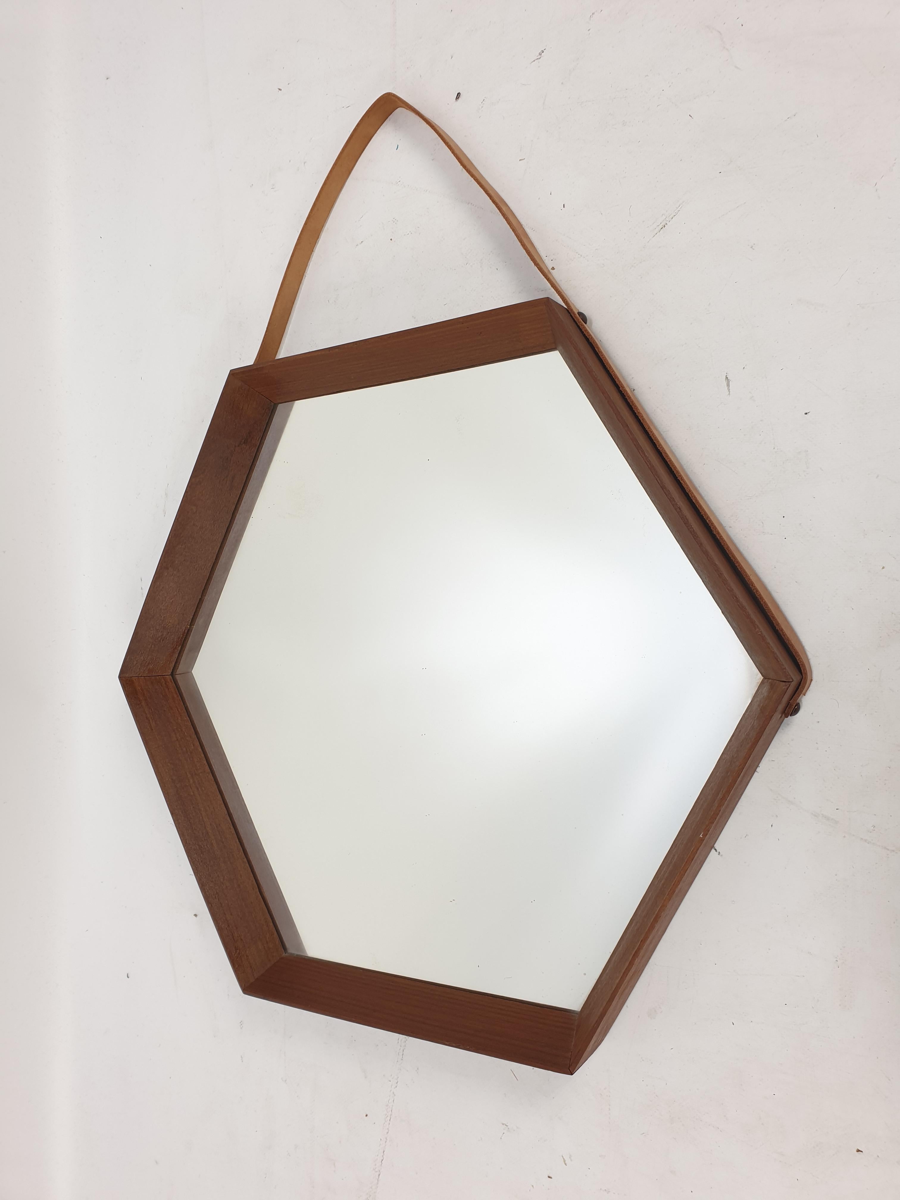 Beautiful and elegant wall mirror in dark teak wood. Made in Italy during the 1950s. To note the work of excellence of the execution of the frame. Smallest vintage signs of wear but no defects.
