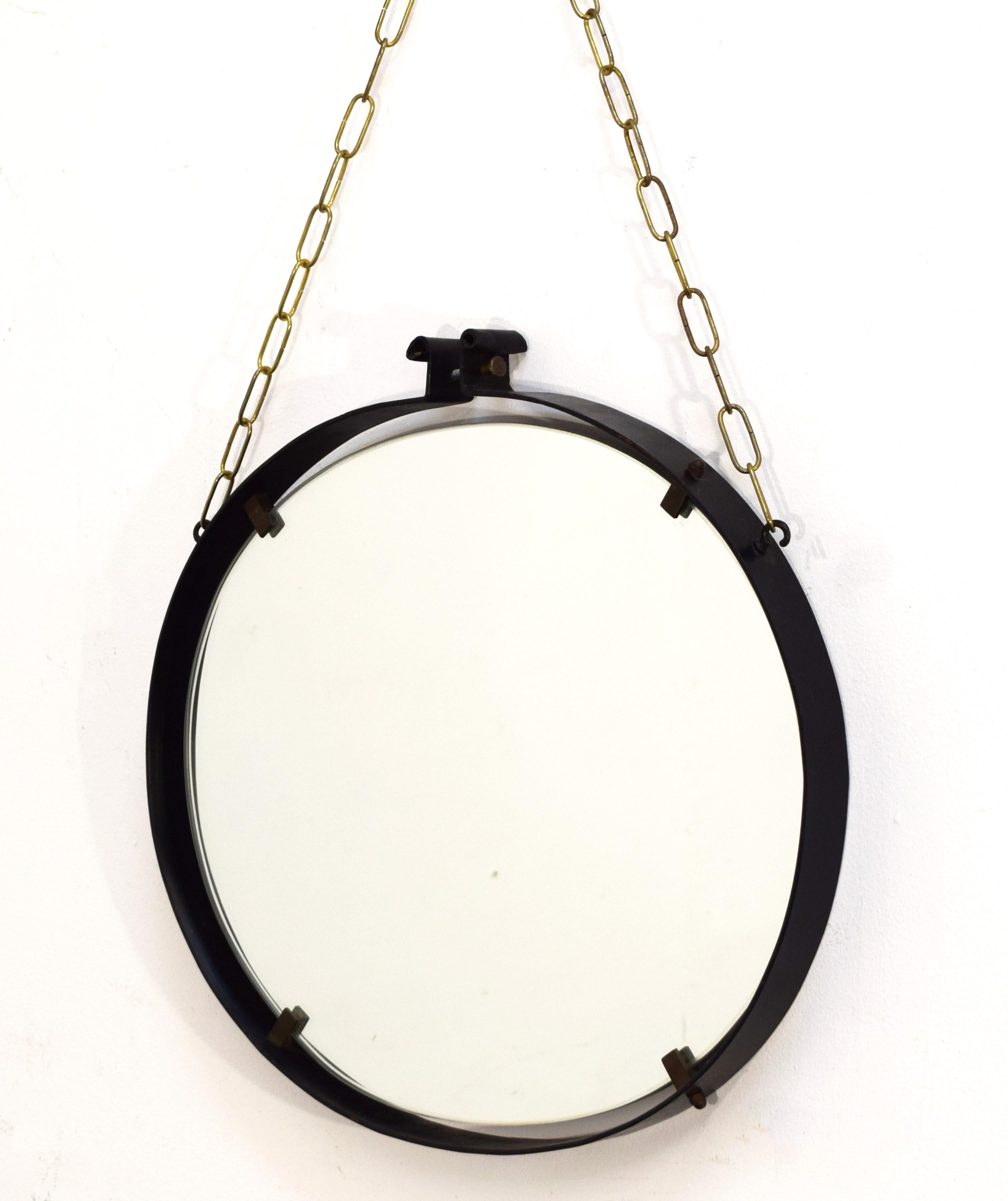 Italian wall mirror, iron, brass and glass, 1960s.
Dimensions:
H total 82 cm. 
Mirror 49x46 cm.
Depth 4 cm.