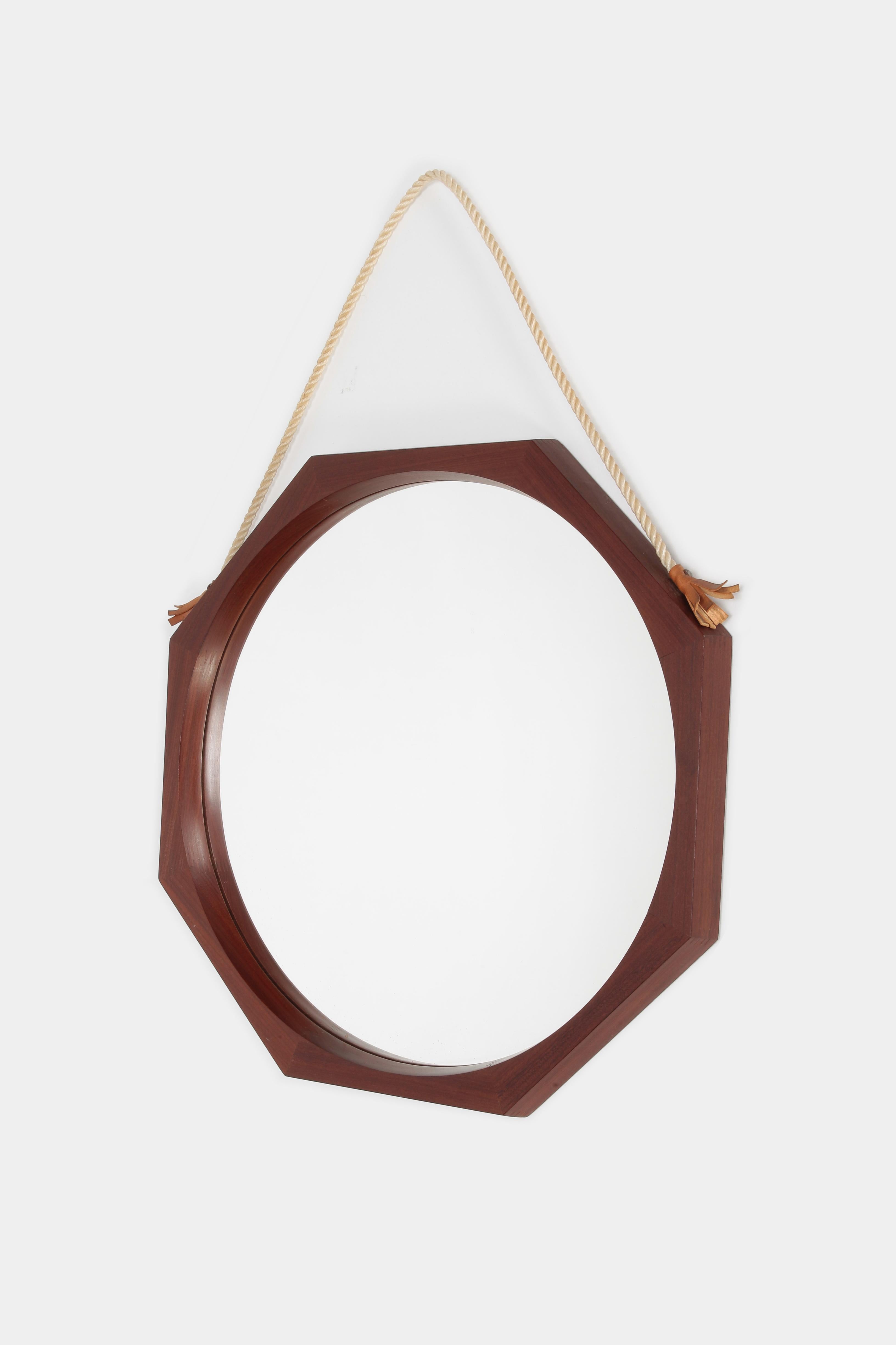 Wall mirror manufactured in the 1950s in Italy. Hanging court with leather fray attached to a edgy solid mahogany frame.