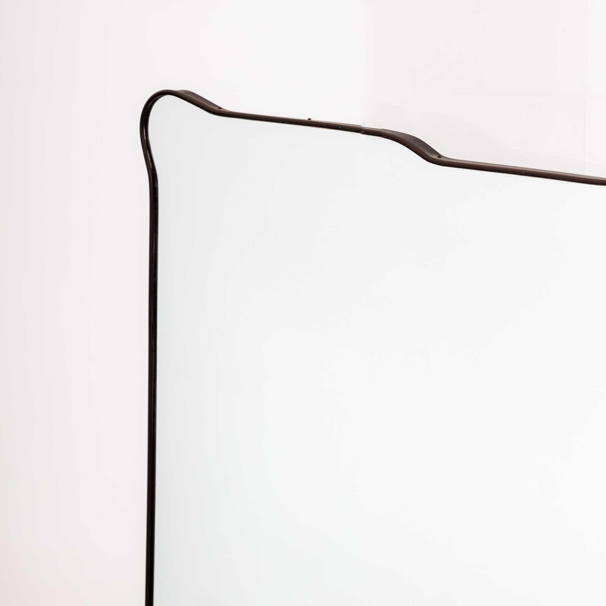 Large wall mirror with narrow metal frame and multiple curved edges.