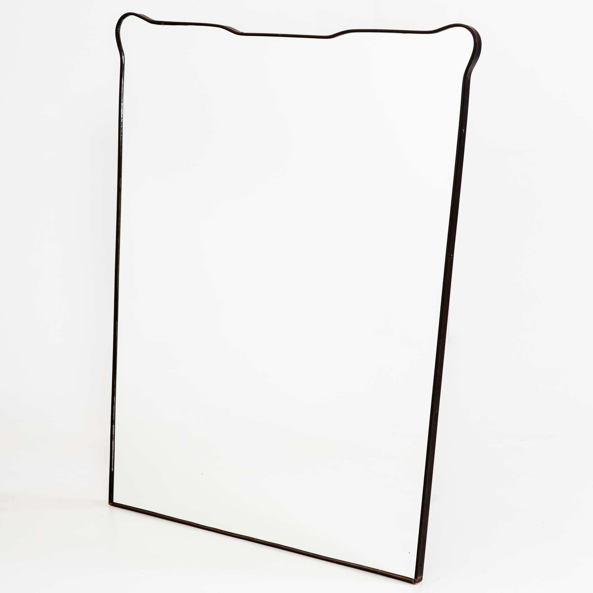 Large wall mirror with narrow metal frame and multiple curved edges.