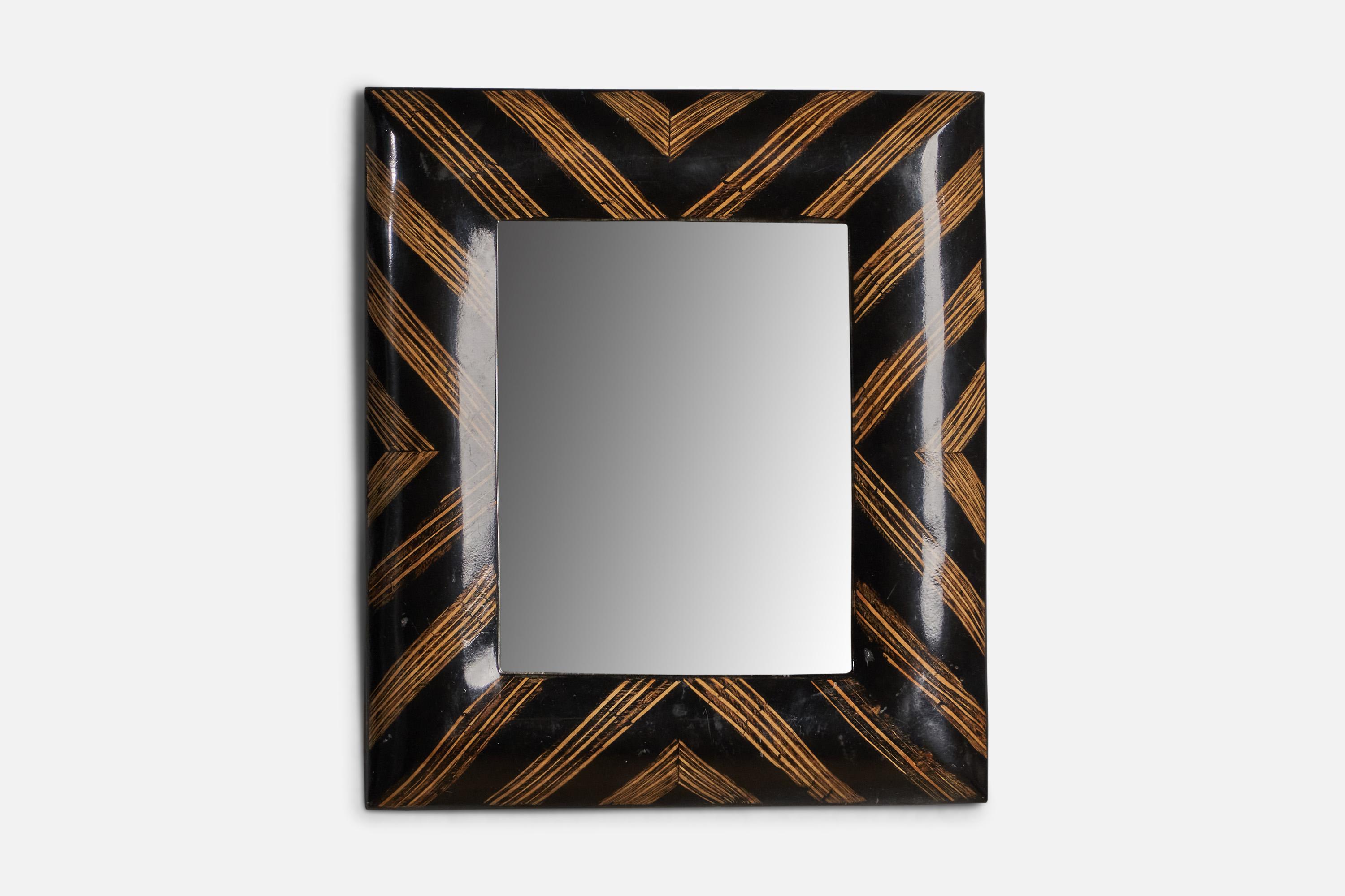 A black and brown resin wall mirror designed and produced in Italy, c. 1940s.