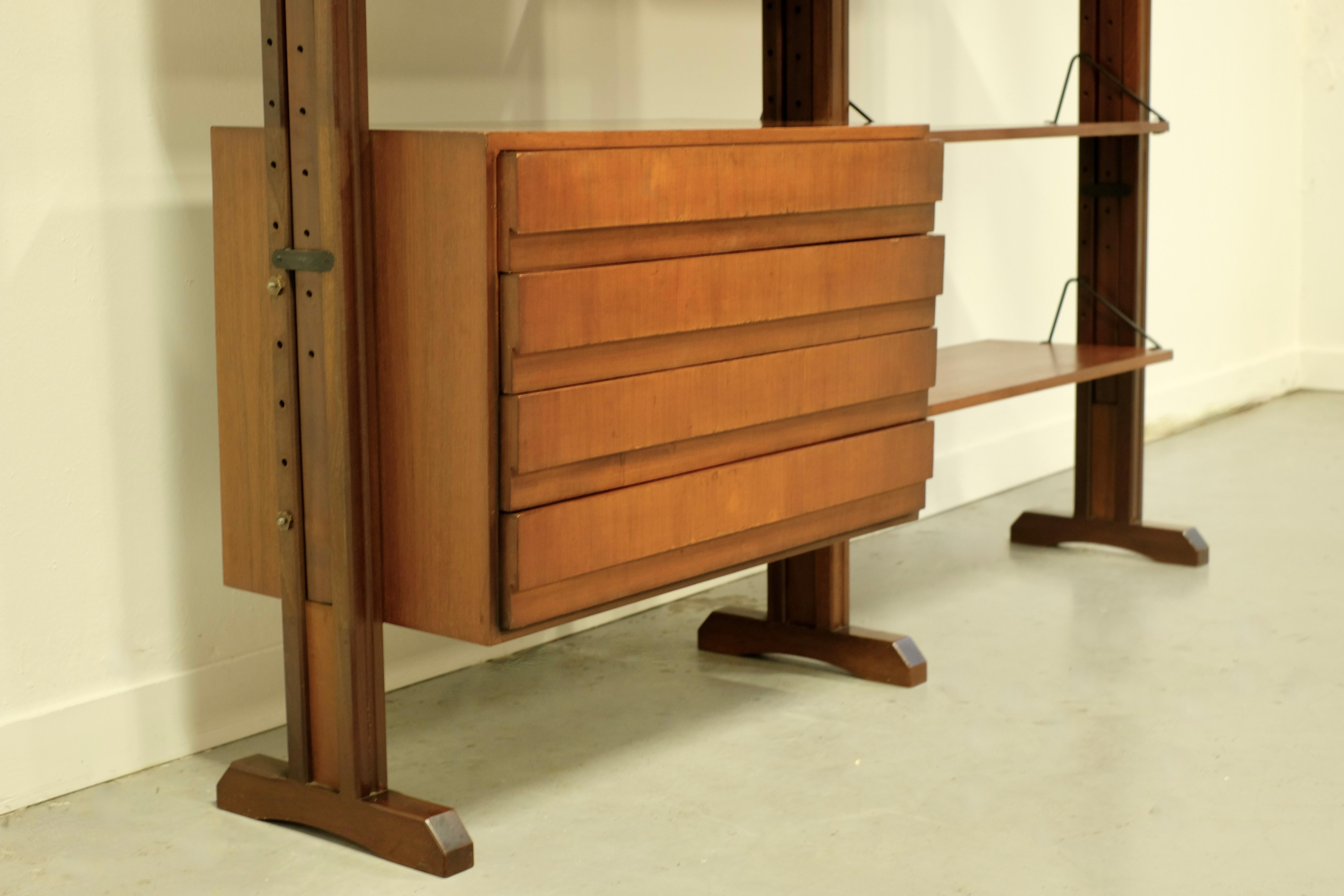 Grande libreria italiana realizzata negli anni '60.

è realizzato in Teak con 3 scatole, 4 ripiani ed è autoportante.
L'altezza della libreria è regolabile: di serie è 215 cm, ma puoi arrivare fino a 300 cm, ma il numero di scatole e ripiani è