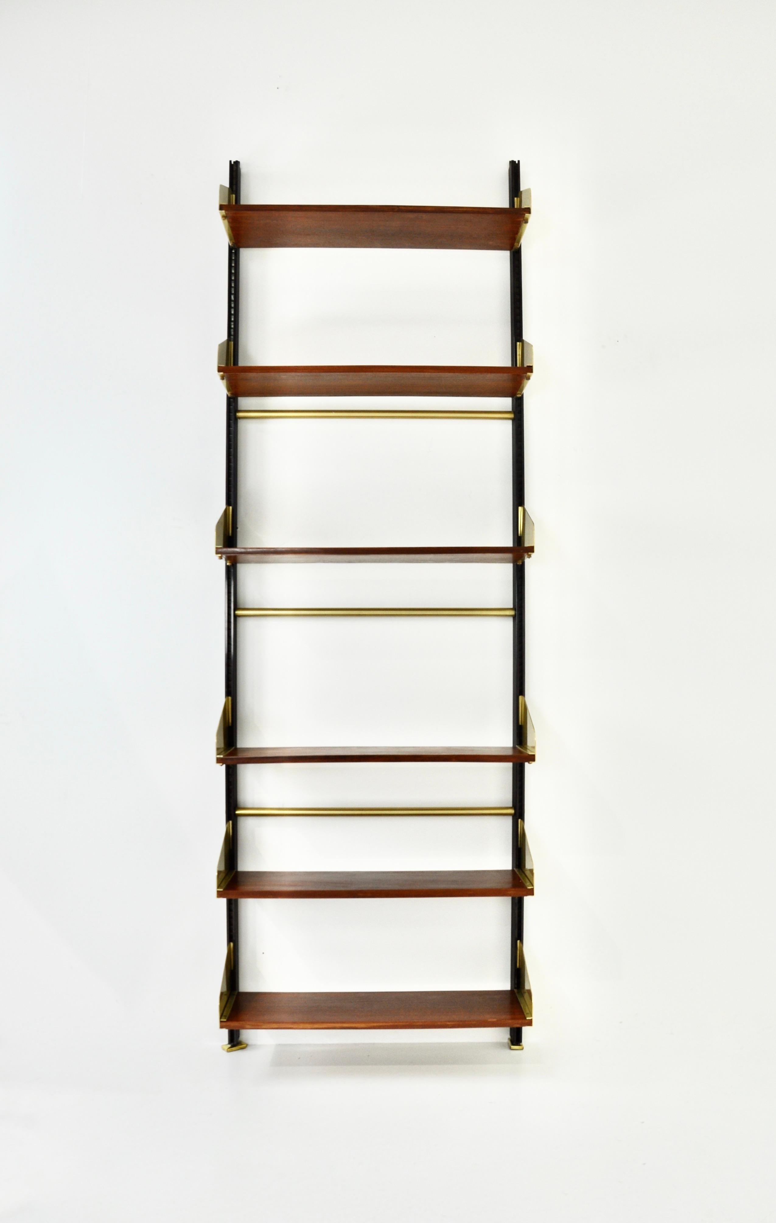 Modular wall unit in wood, brass and metal with 6 shelves. Height-adjustable. Wear due to time and age of the wall unit.