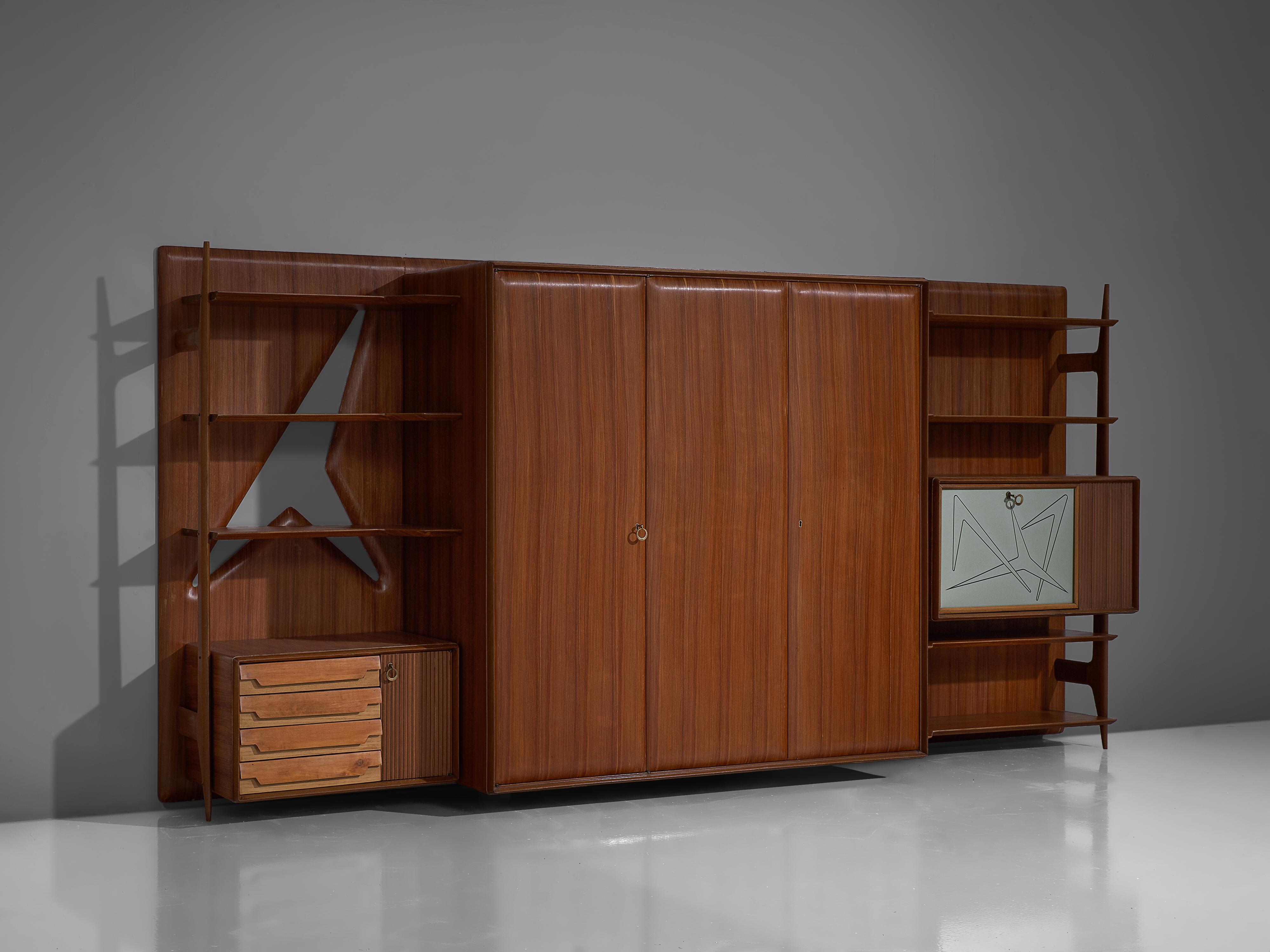 Wall unit, mahogany, lacquered wood, brass, glass, Italy, 1960s.

This Italian wall unit convinces both visual and functional. It offers a variety of different storage possibilities. A three door cabinet is placed in the centrum which provides a