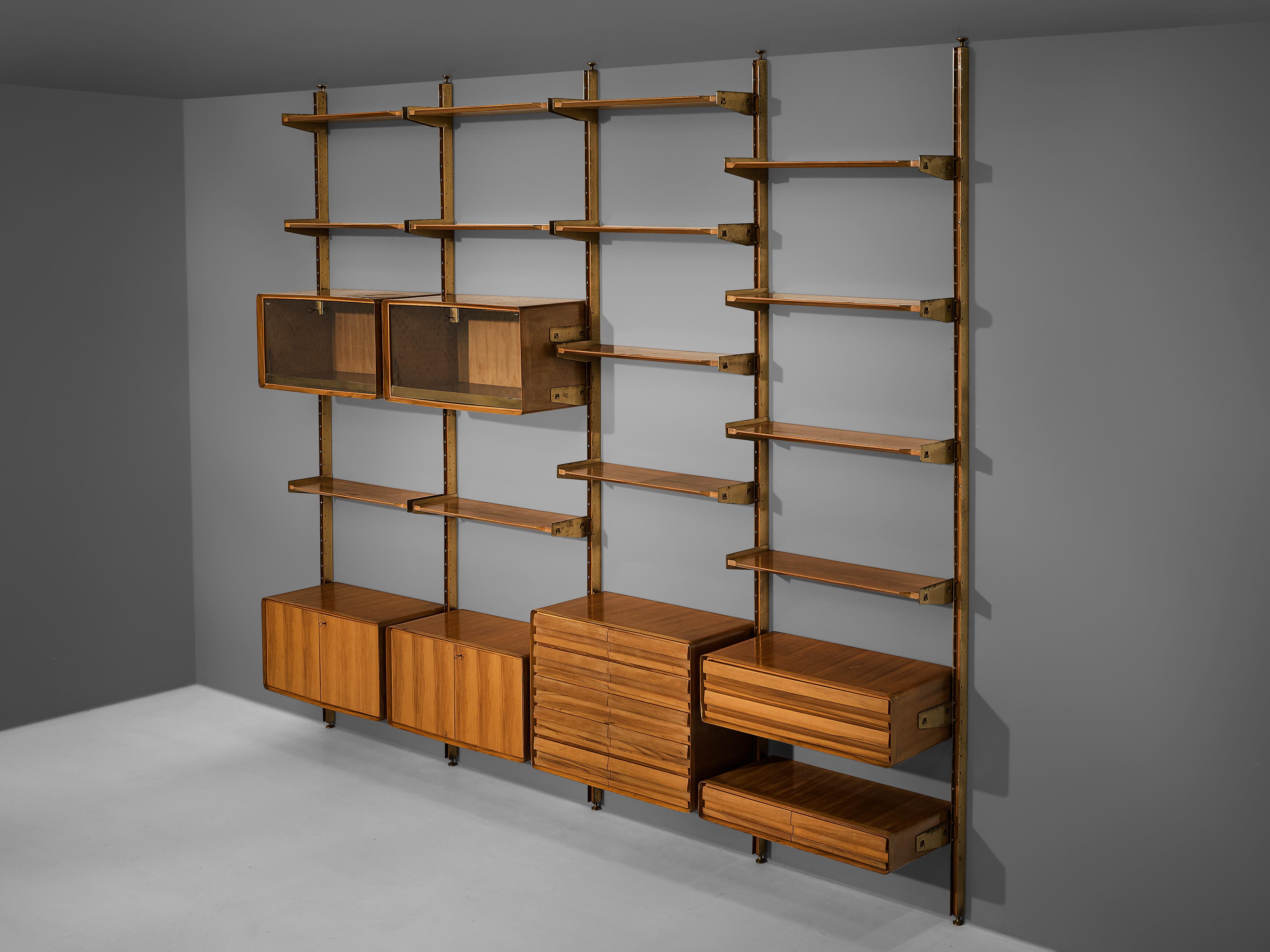 Wall unit, walnut, brass, glass, Italy, 1950s

Admirable Italian wall unit with four columns and diverse storage systems. Multiple shelves are attached to the brass wall fixture by polygonal sides. The shelves and all seven compartments can be