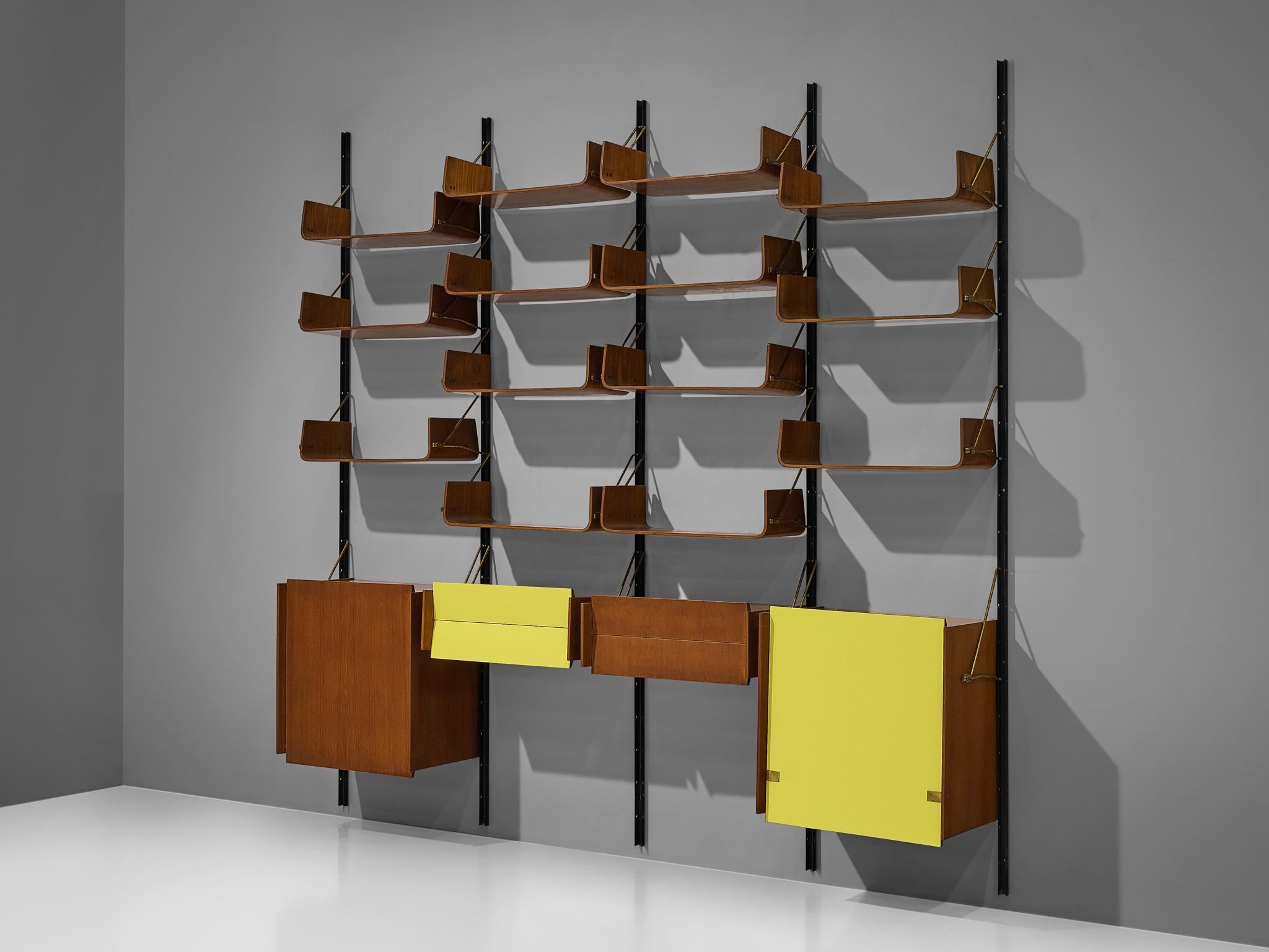 Wall unit, walnut, plywood, brass, black lacquered metal, Italy, 1950s

Large Italian wall unit in four sections. All sections have cabinets and several shelves that are adjustable at any height. The shelves are made of bent plywood that is curved