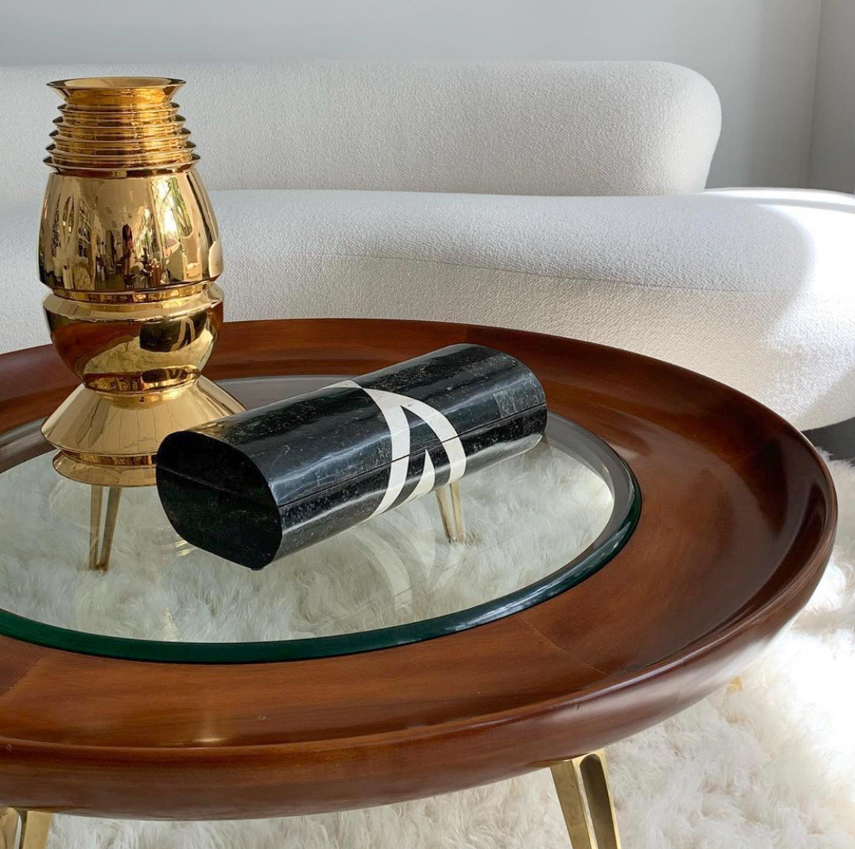 An incredible Italian coffee table with rounded concave form and brass legs in the style of Gio Ponti, circa 1950s. A 47