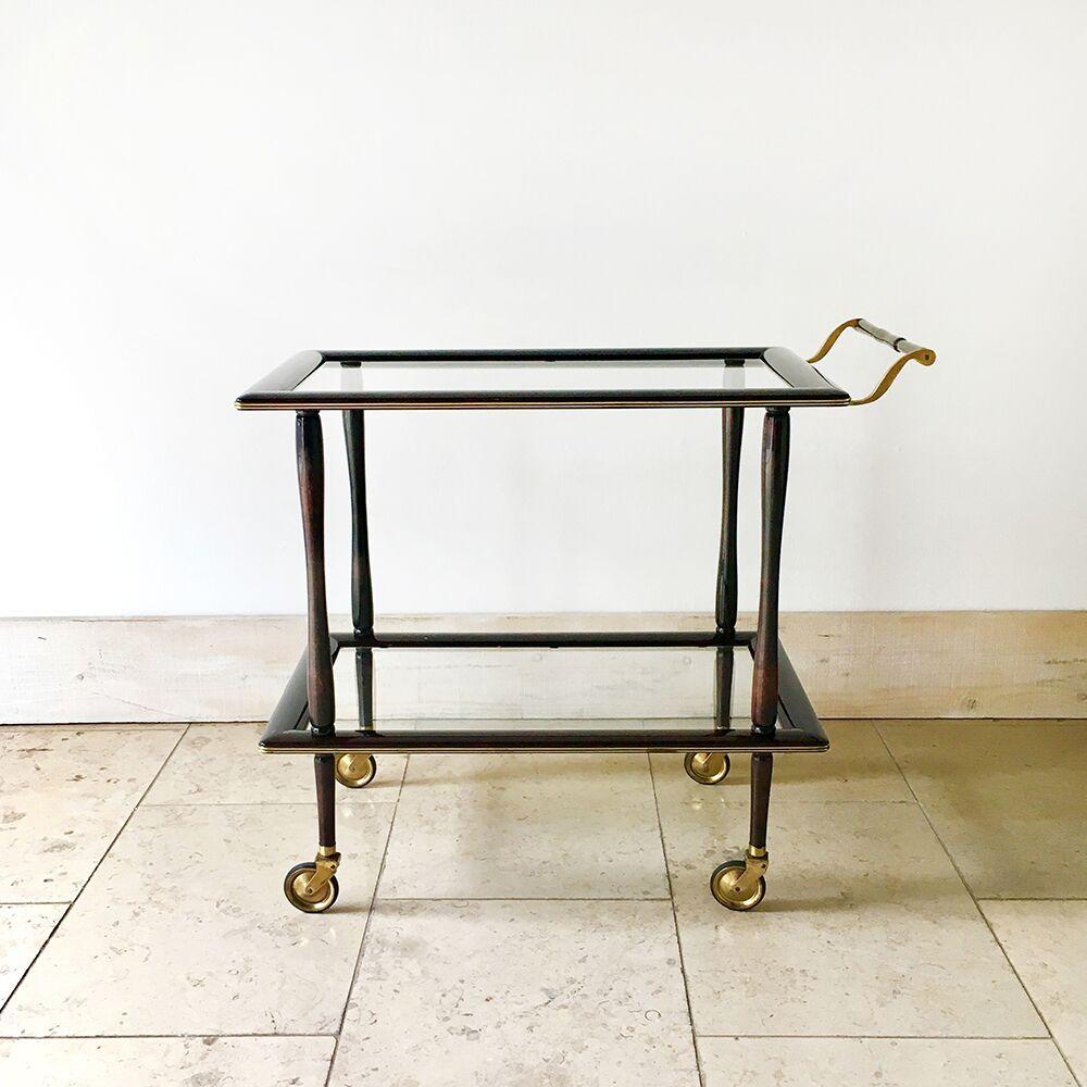 Italian rectangular polished walnut and brass framed two-tiered barcart with inset glass shelves on brass castors and with a brass handle, 1960s.