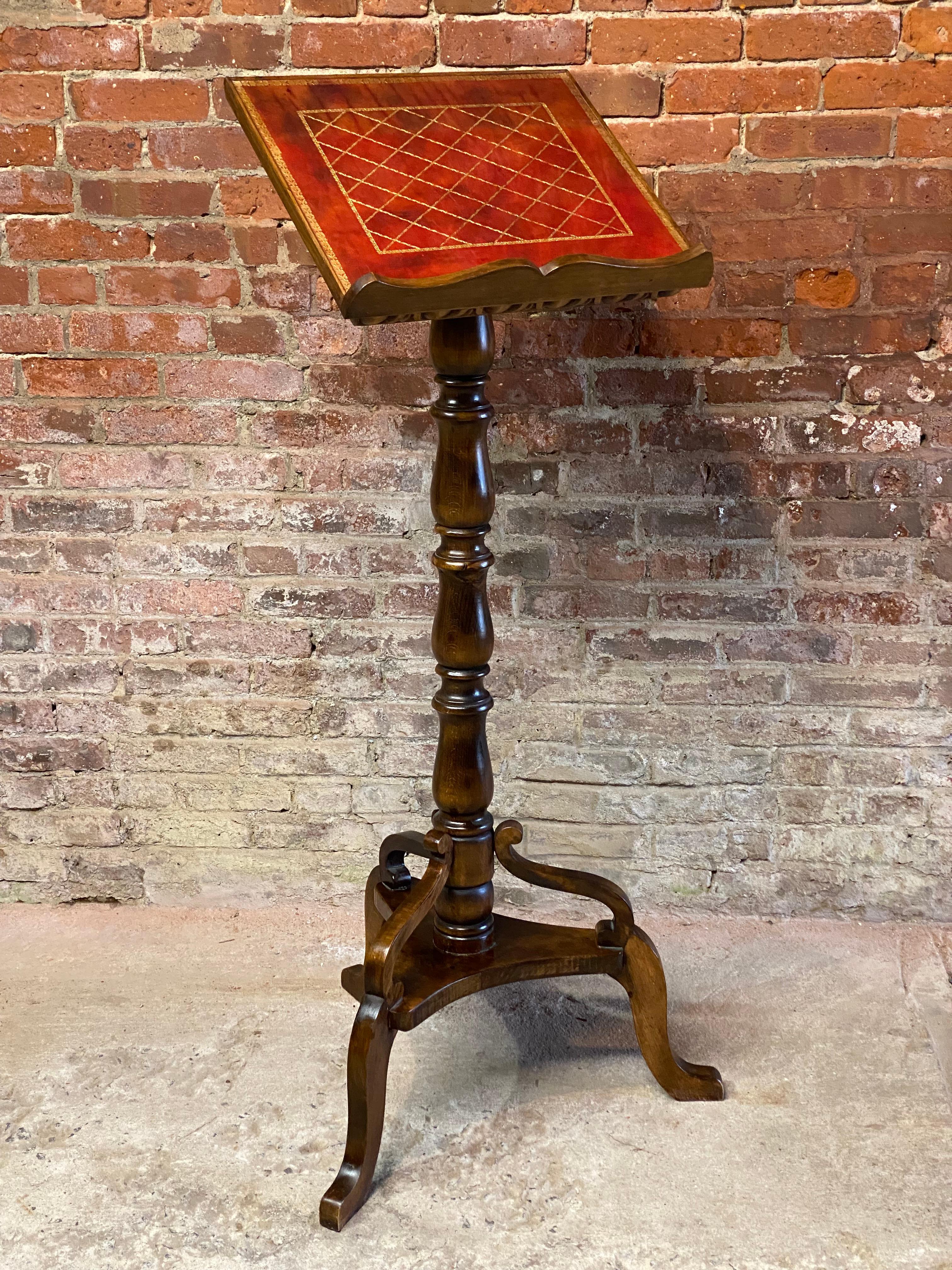 Italian walnut and gold embossed leather lectern. Circa 1970. This wonderful book stand/lectern brings a certain refinement to any room. The angled surface, which would retain a book or open ledger, has a gold embossed floral edge framing a diamond