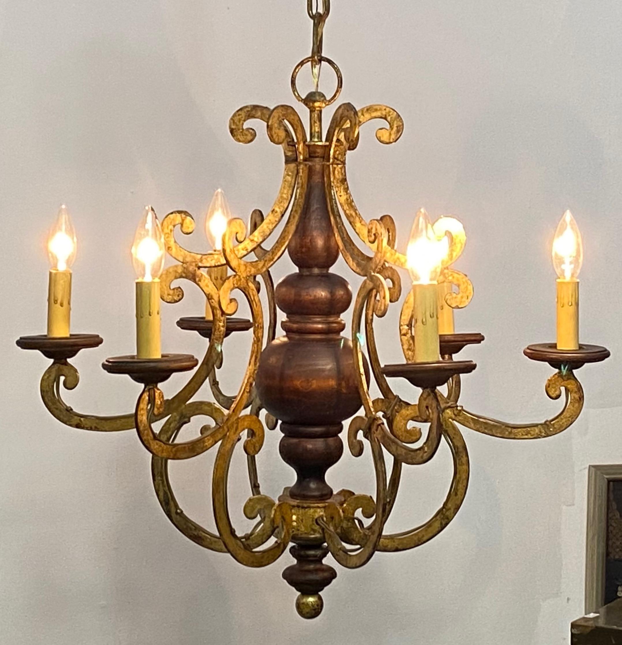 A stylish walnut and gilt wrought iron 6-arm ceiling light.
Recently refreshed and re-wired.
Measurement for just the light fixture is 24 inches high. We can adjust the chain length to your specs.
Italy, circa 1960's.

 