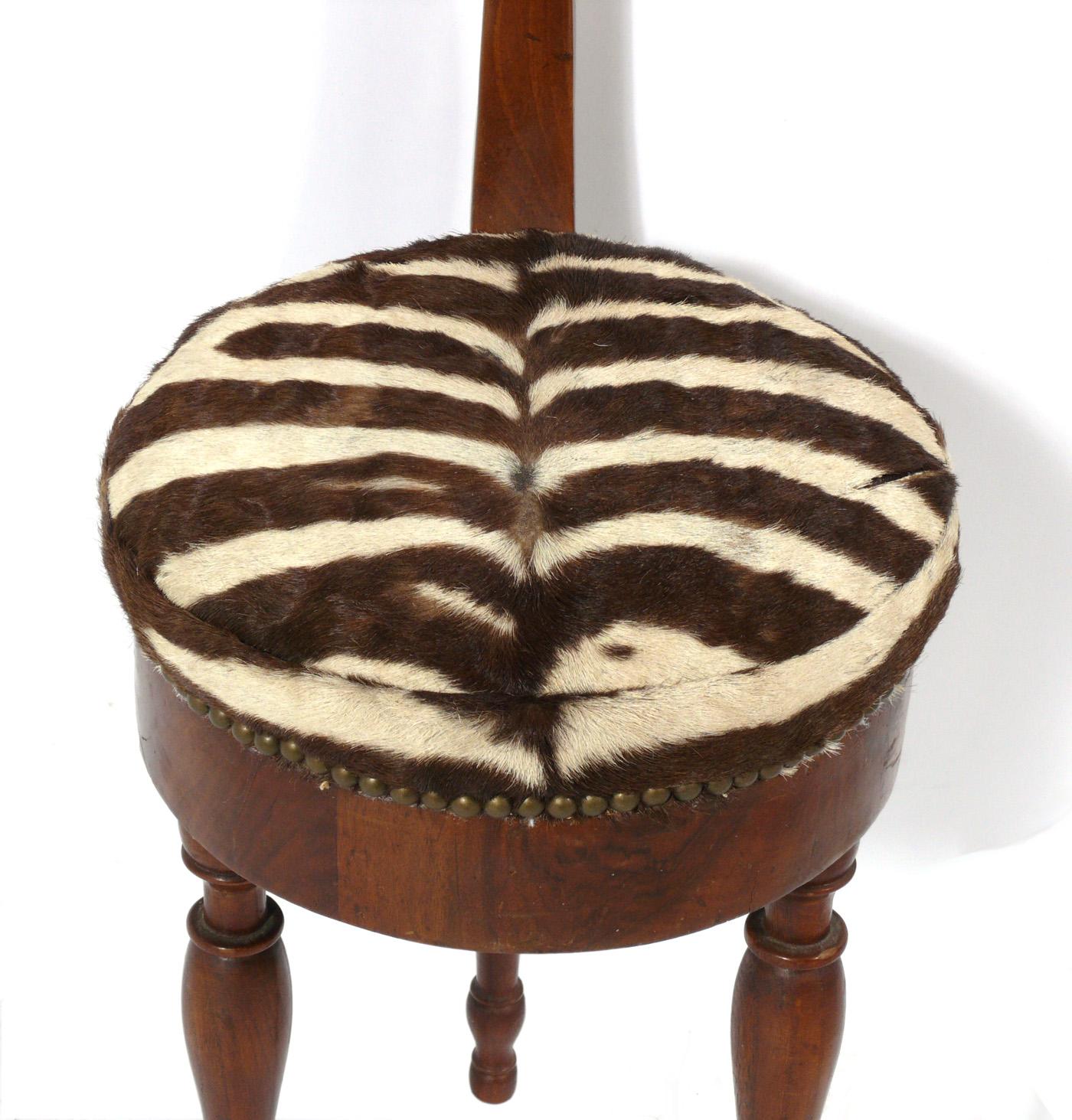 Sculptural Italian walnut and zebra hide tripod chair, Italy, circa 1950s or earlier.