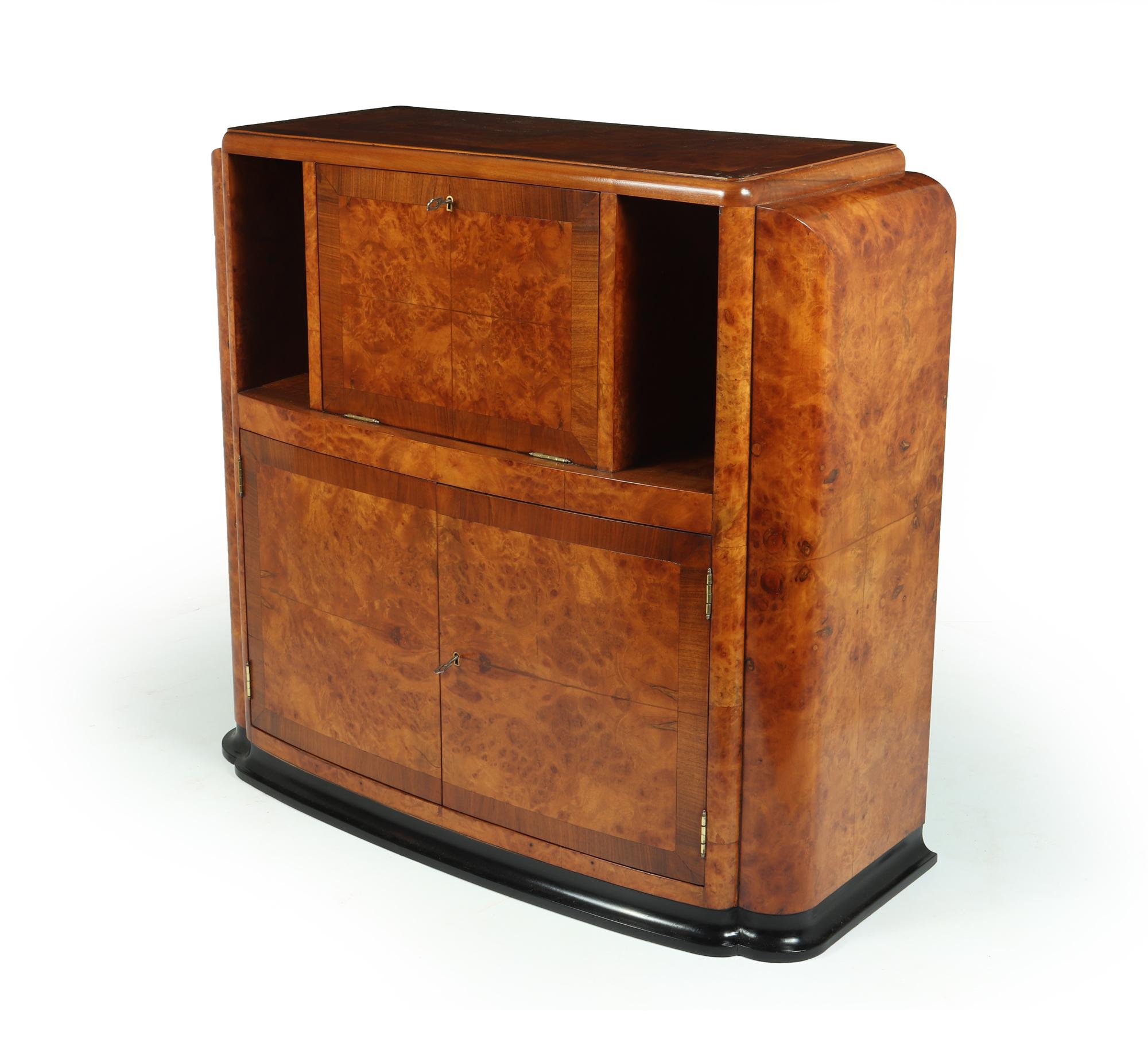 An exceptional and rare Art Deco cocktail cabinet, in burr walnut and cross-banded, with a fall down lockable drinks area, and a pair of lockable doors below, two original keys supplied with working locks, the cocktail is a great size, it retains