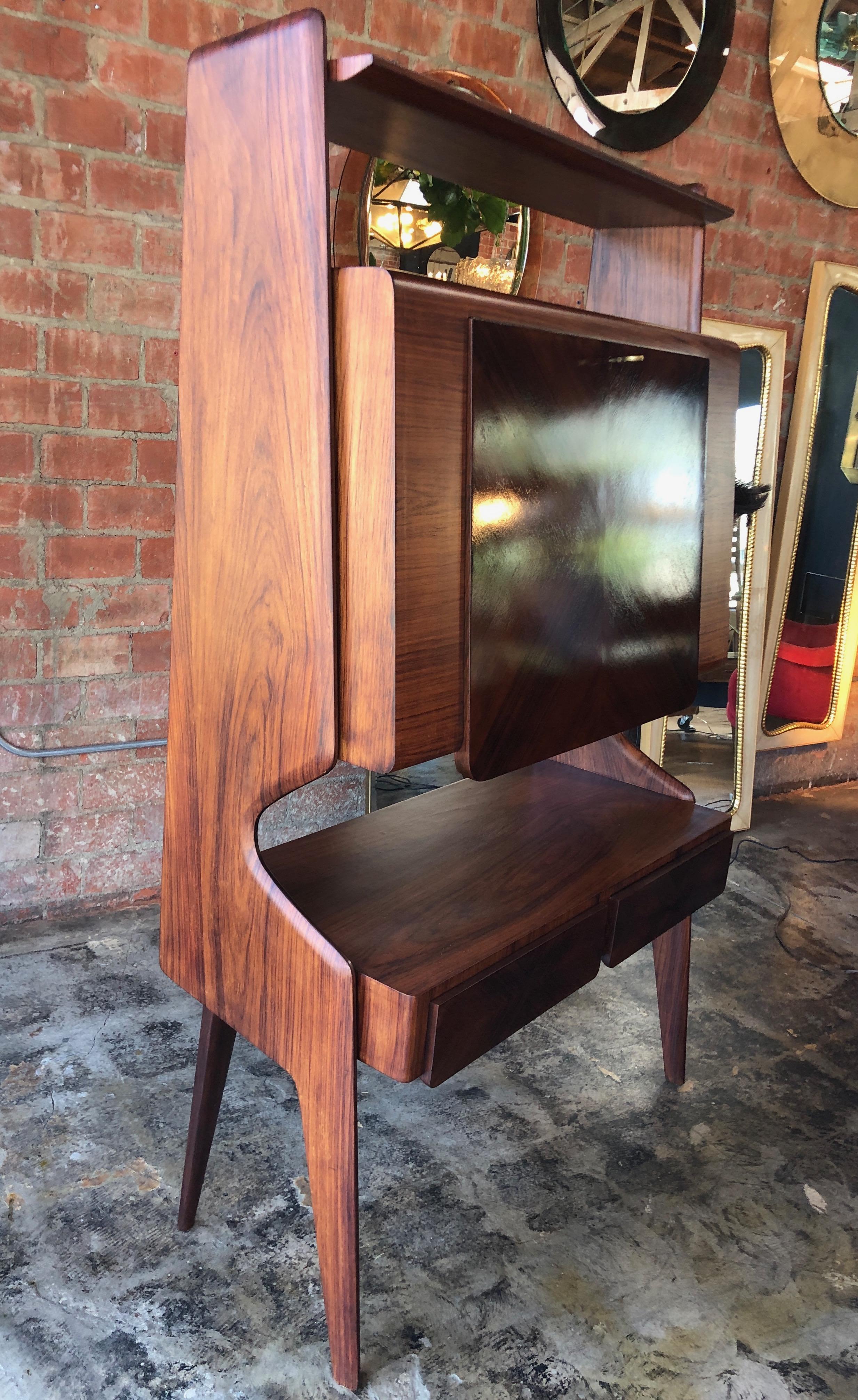 Italian walnut bar cabinet by Vittorio Dassi, 1950s. This Italian midcentury walnut bar cabinet dating from the 1950s was designed by Vittorio Dassi (Milan, 1893-1973). The opening reveals the dry bar. It features two sycamore lined cabinets