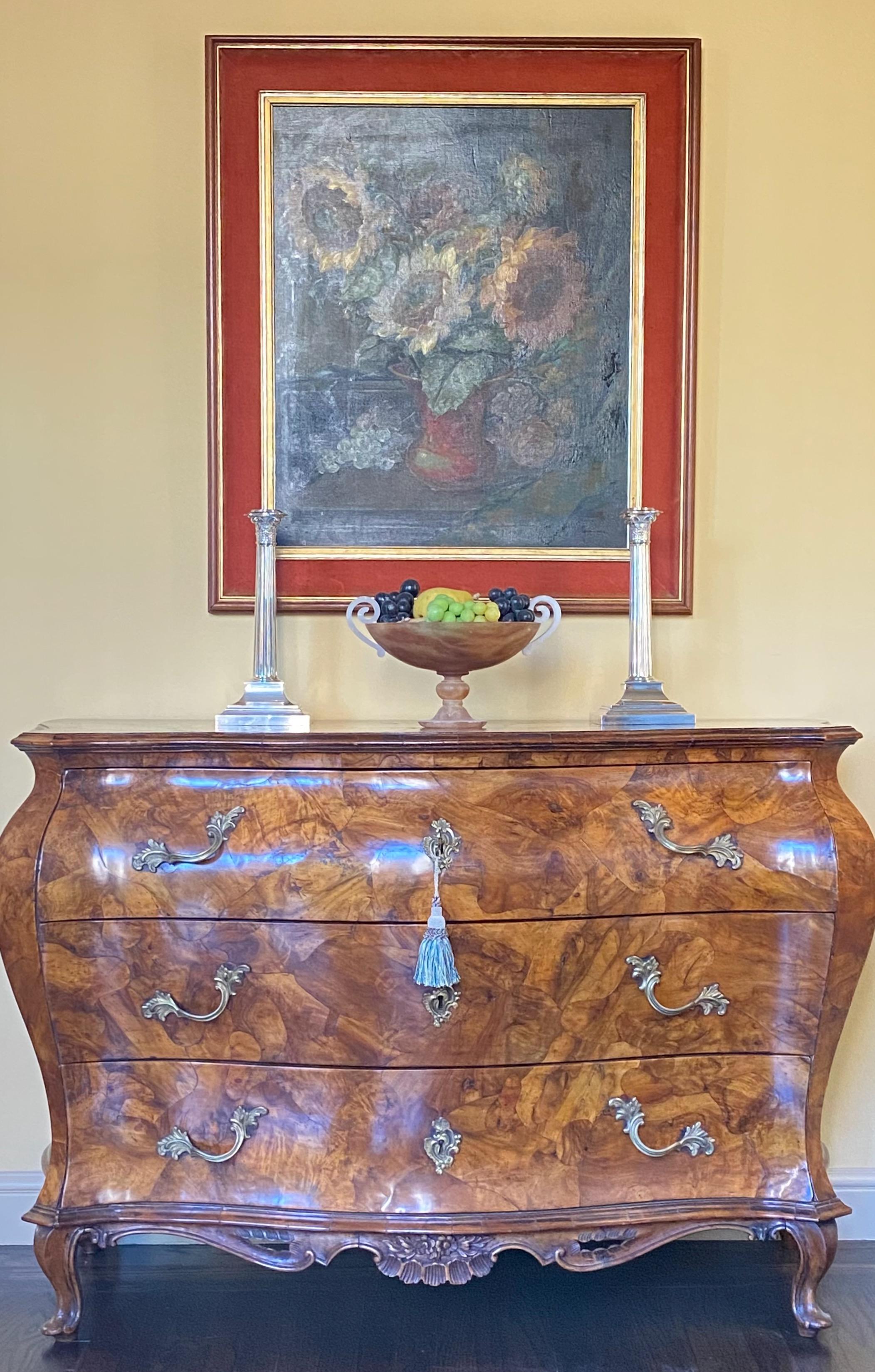 An exceptional early 19th century Italian walnut patchwork veneered chest in excellent antique condition. Entire commode with highly figural patchwork walnut , having original locks, keys, and hardware. 
All three drawers are paper lined and move
