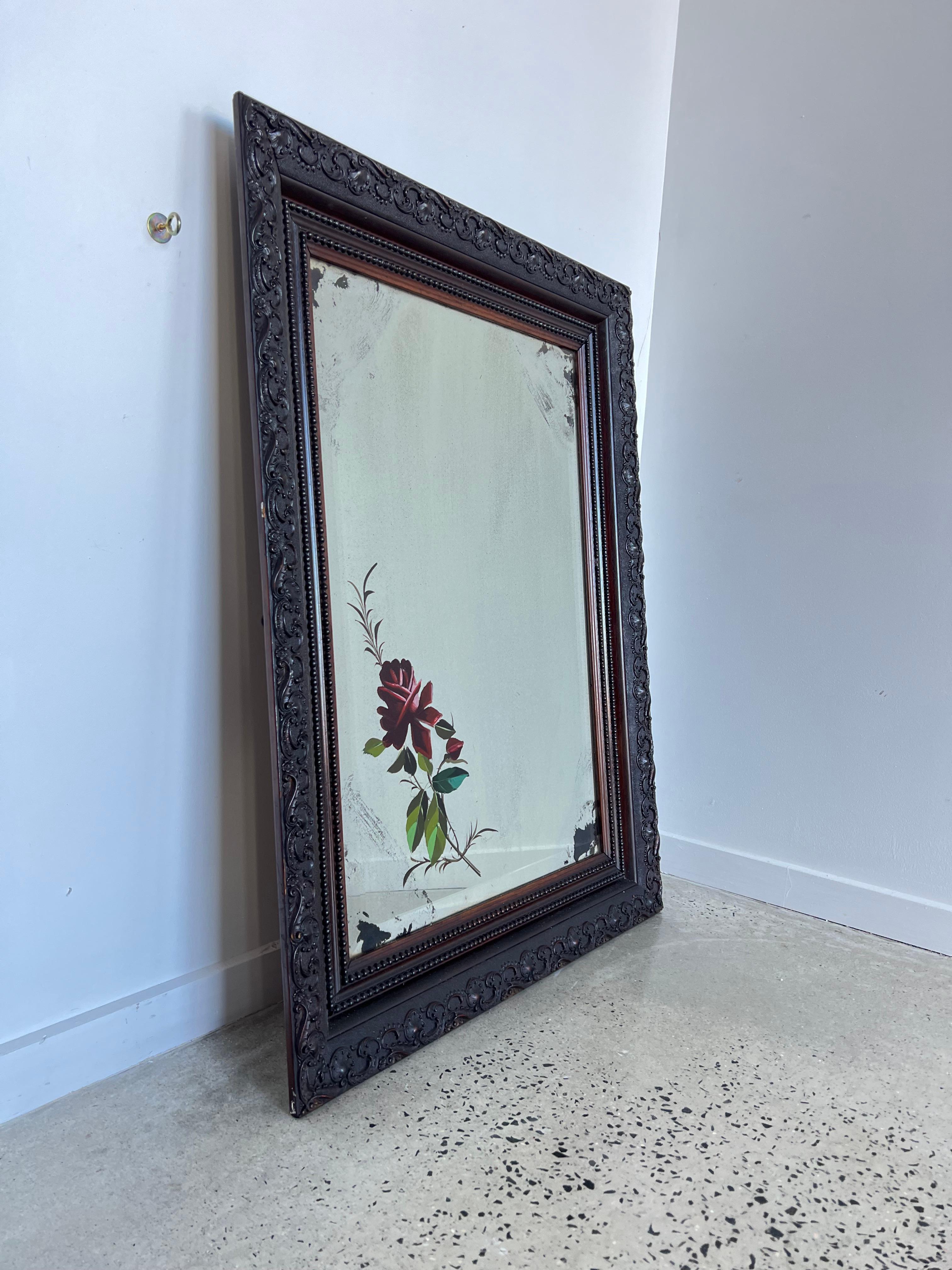 1950s Walnut carved frame Italian Art glass mirror.
Beautiful mirror with completely carved frame, hand painted flower art work on the glass.
 