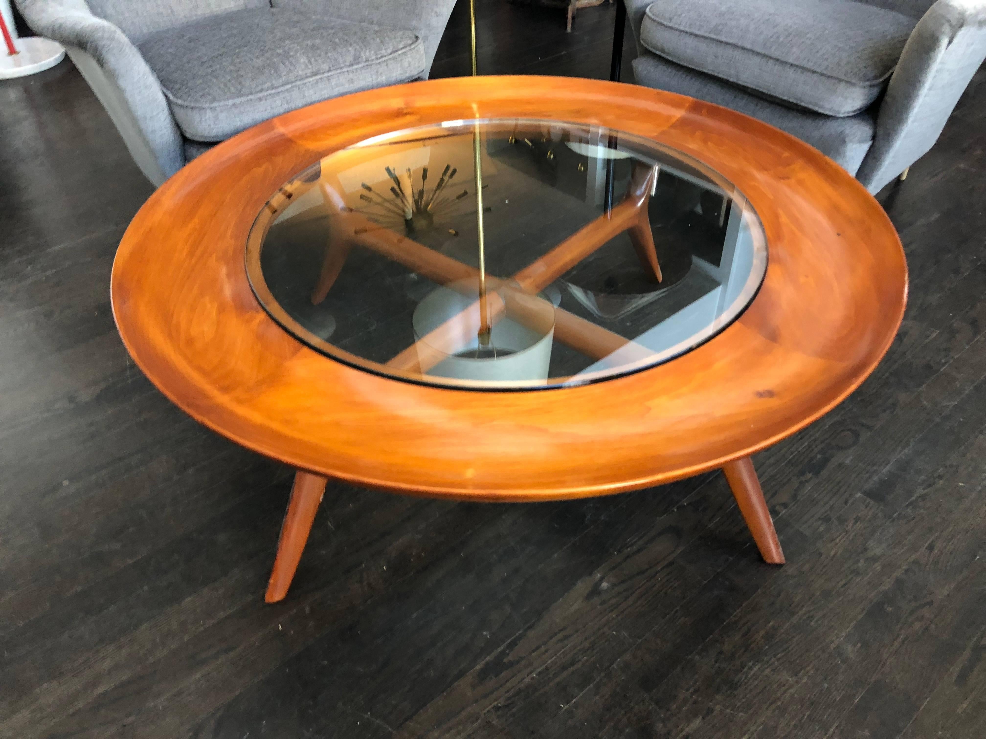 Elegant walnut coffee table adapted from Gio Ponti design style. This table features four curved legs with curved/molded stretcher and convex shaped top with glass center inset top. Custom options are available in size and finish. Made in