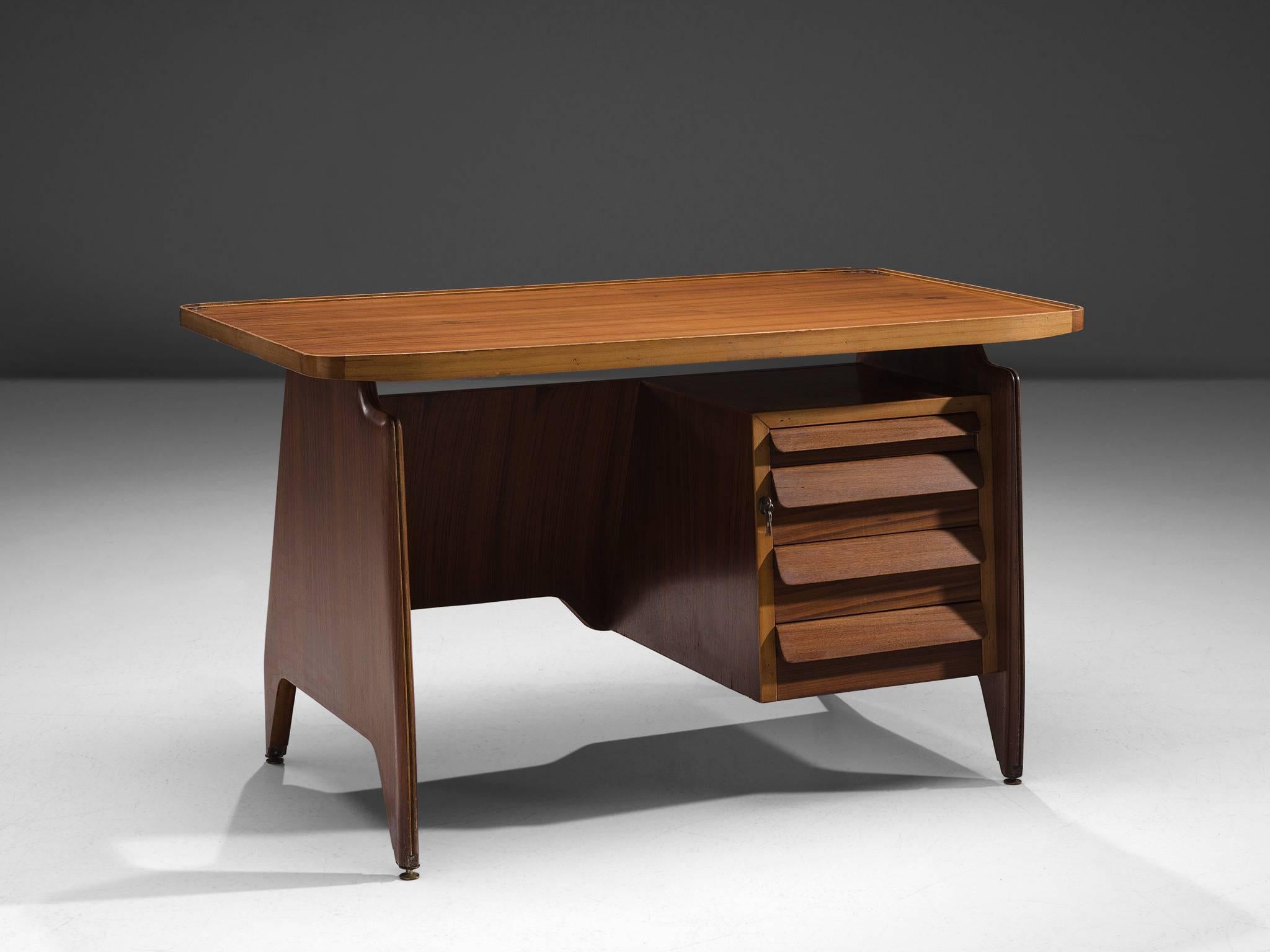 Writing table, walnut, Italy, ca. 1950 

This small writing desk is designed in the 1950s. The design features sharply curved edges combined with fluent, sculptured forms. The piece is in a very good condition. It shows that all elements are made