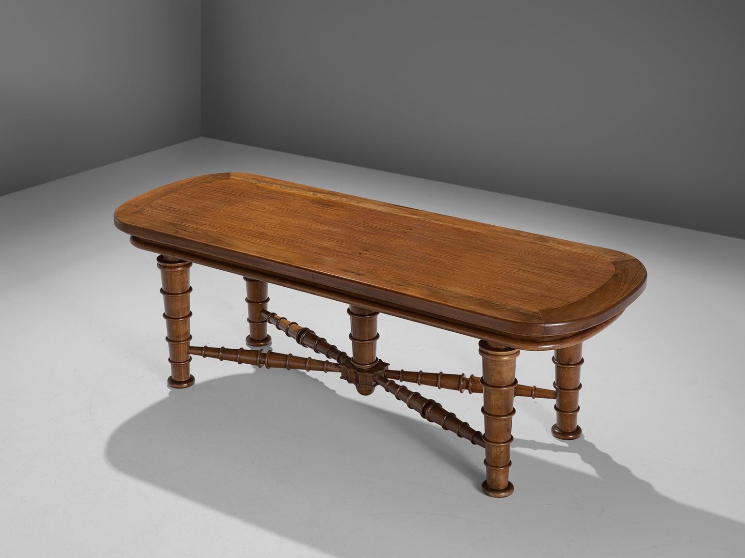Dining table, walnut, wood, metal, Italy, 1940s

This early midcentury Italian table has an rounded and bordered rectangular top. The decorative legs are tapered and feature five circles each from top to bottom. The table has a fifth 'leg' in the