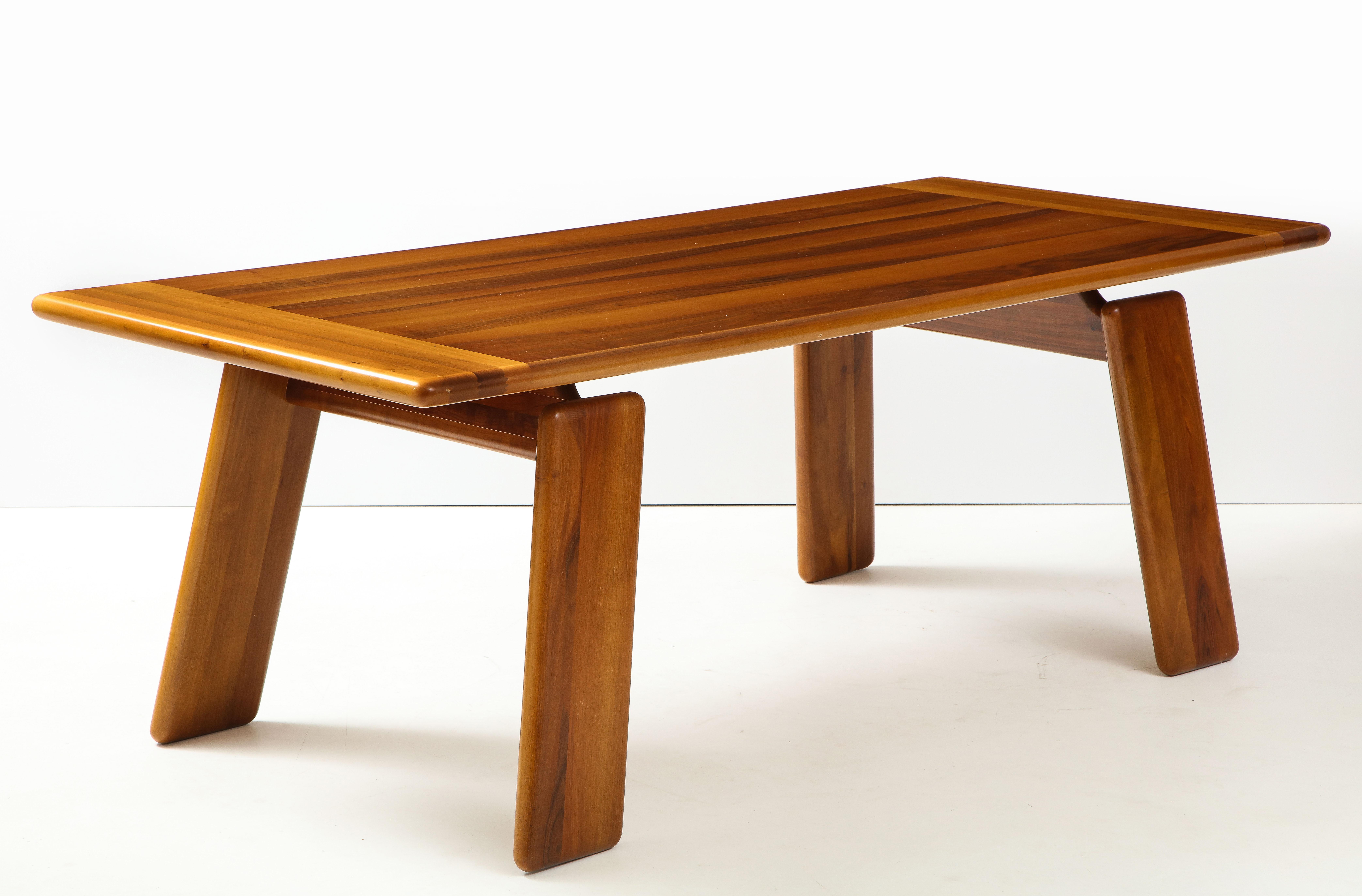 An Italian walnut floating dining table designed by Afra & Tobia Scarpa, made by Sapporo for Mobil Girgi, 1970's. The canted legs are connected to a horizontal stretcher, which support the top, creating the visual effect of a floating table top. The