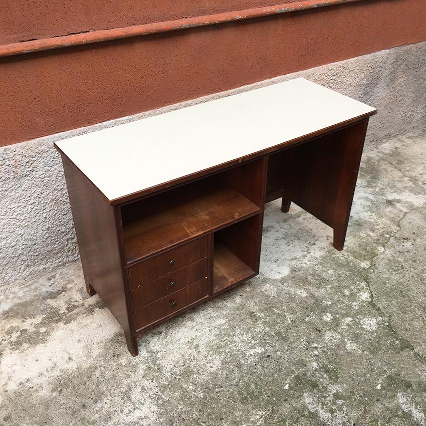 Italian walnut, Formica and brass writing desk, 1960s. Beautiful writing desk, with top in white Formica and three drawers; equipped brass handles and glove compartments, 1960s.