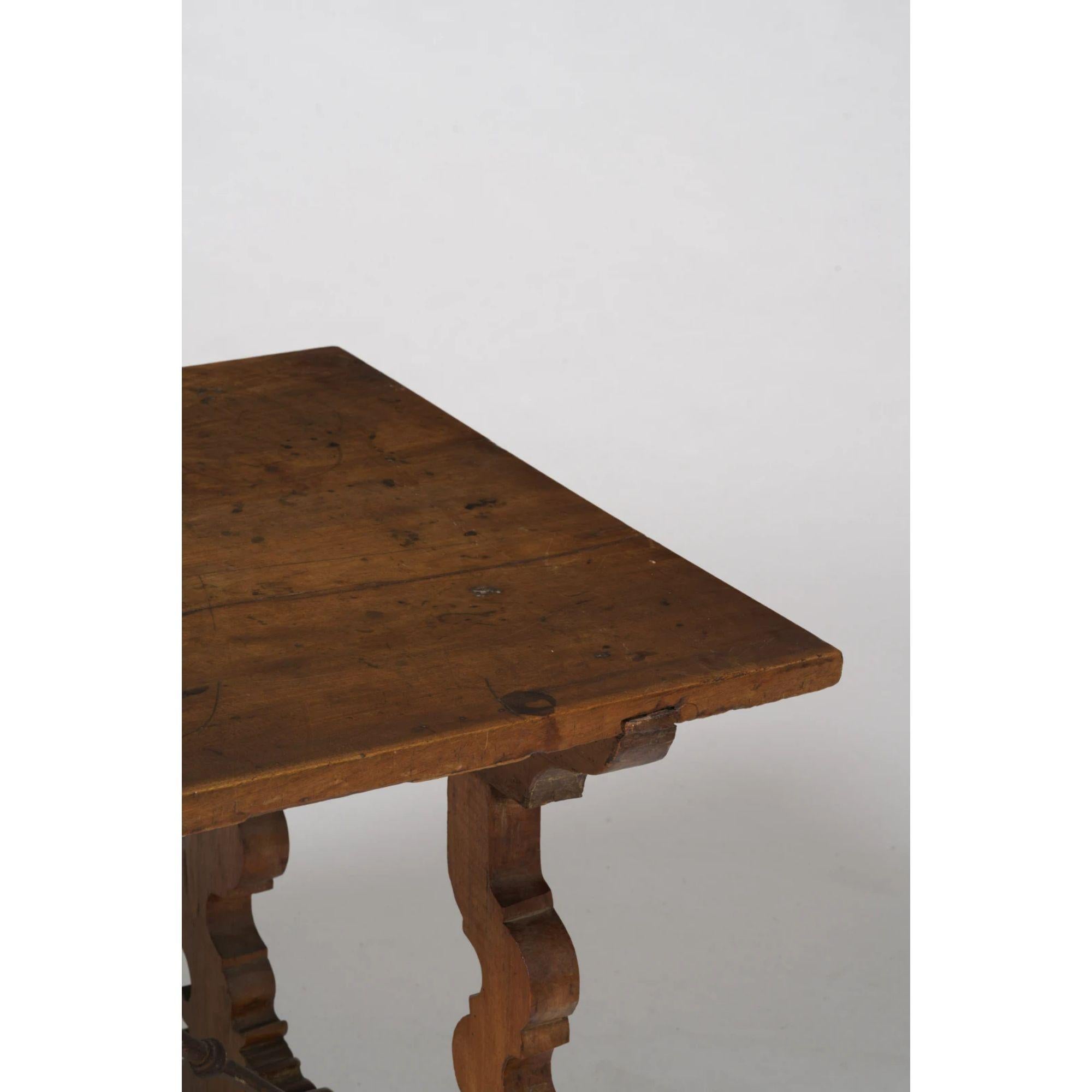 Italian Walnut 'Fratino' table, 19h Century

A well proportioned 19th Century Italian 'Fratino' table in walnut, with lyre shaped legs and wrought iron supports.

Solid construction with a rich patina. Various old knocks, stains and splits that