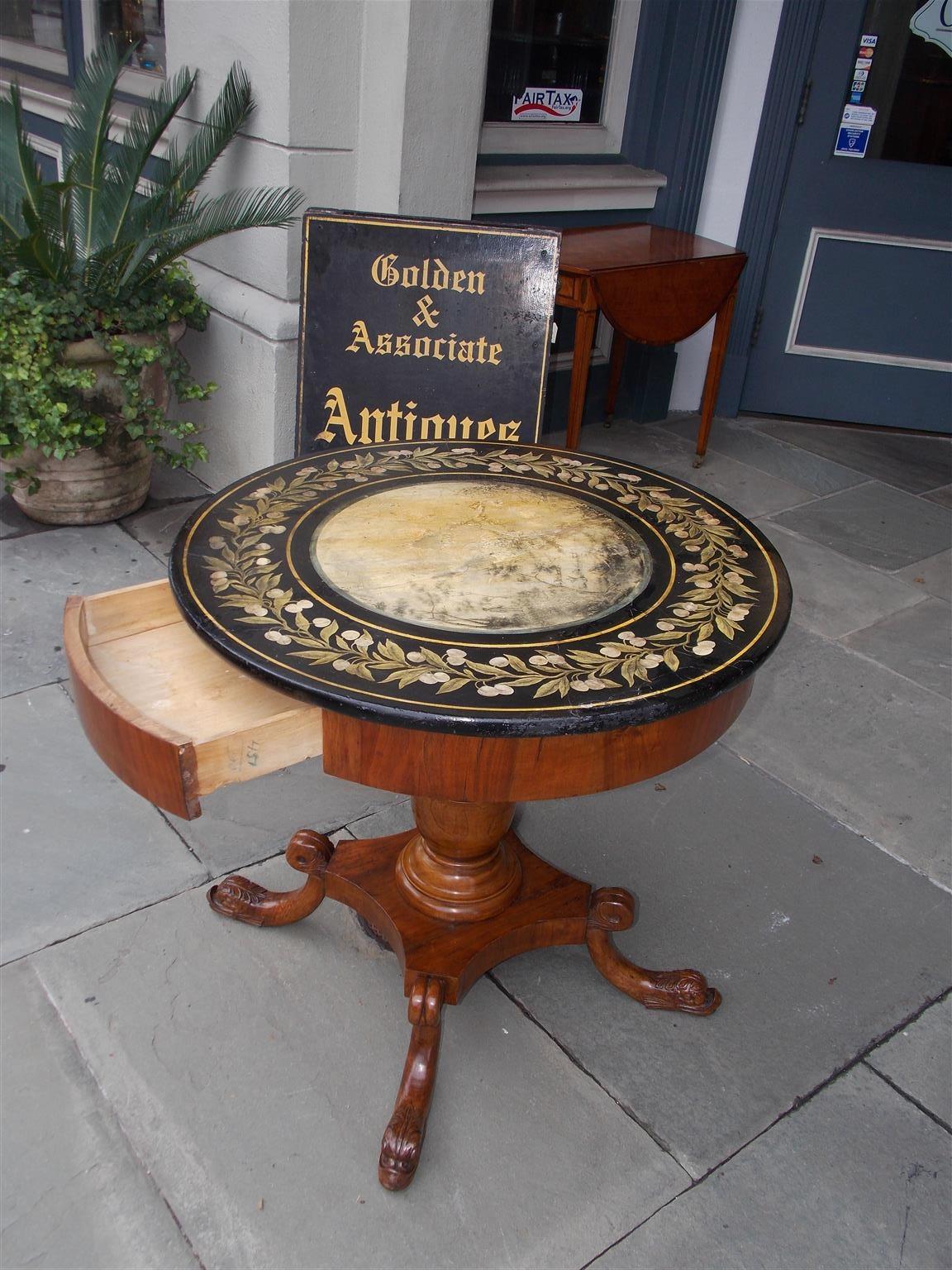Italian walnut one drawer hand painted floral and faux marble center table with a turned bulbous ringed urn pedestal, carved squared inset plinth, and terminating on four original hand carved dolphin feet, Early 19th century.
Measures: Center table