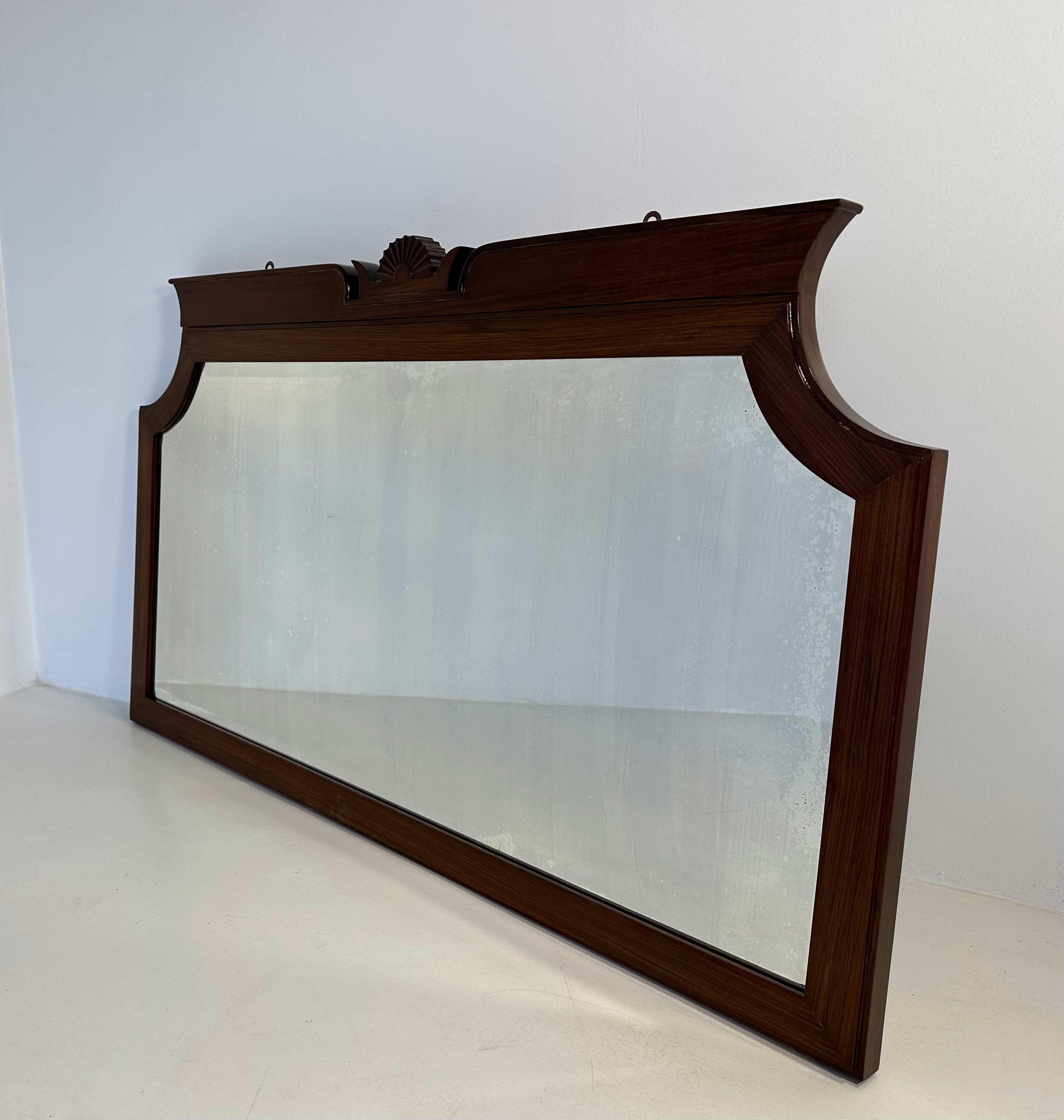 This mirror was produced in Italy, in Cantù (small village in the north of Italy, next to Milan), by Paolo Lietti & Figli and designed by Gio Ponti. 
This mirror in particular was manufactured by Luigi Brusotti in the 1927/1928. It has a label on