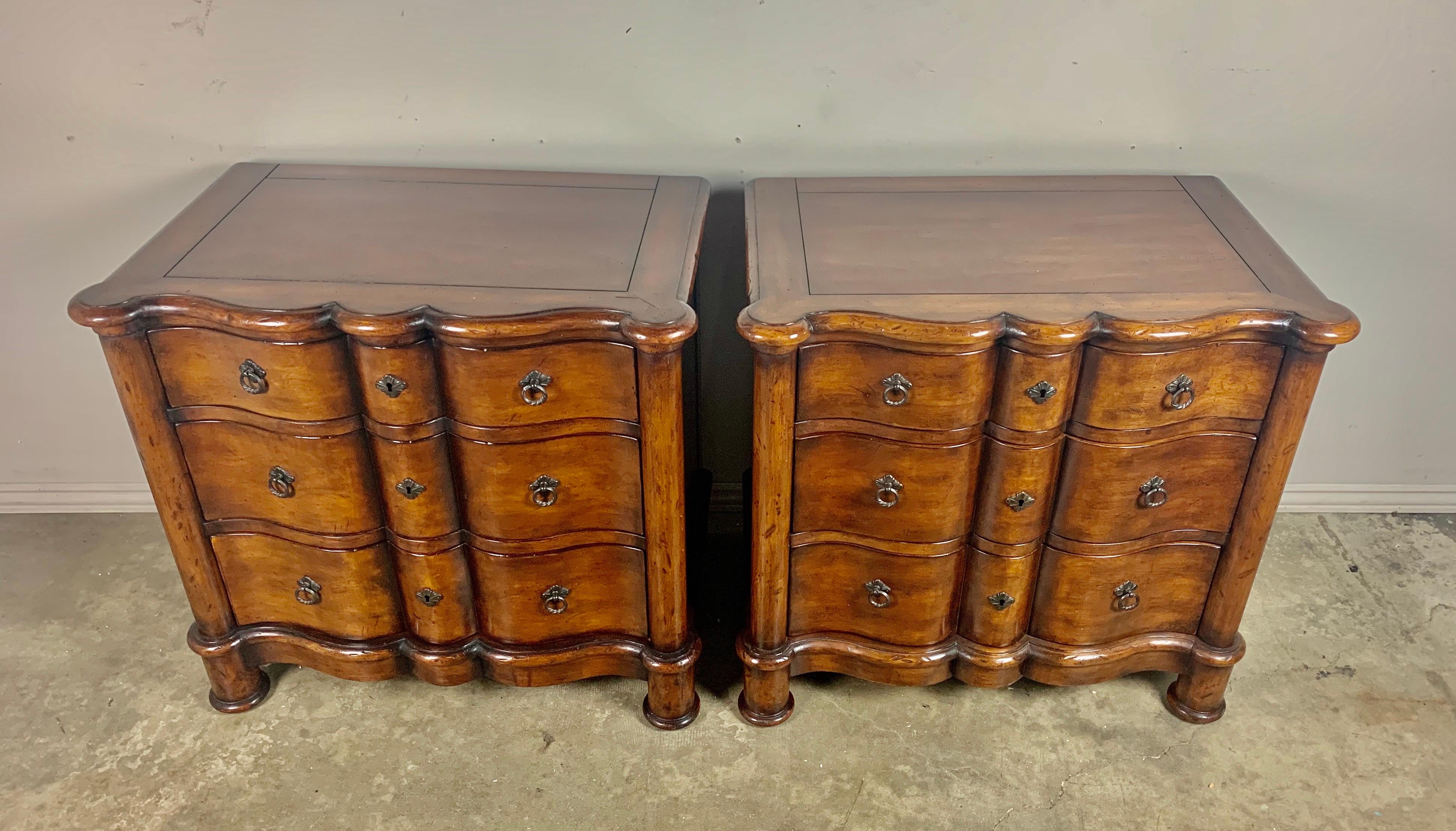 A pair of Italian walnut 3-drawer chests with beautiful scalloped fronts. The chests stand of four cylindrical feet.