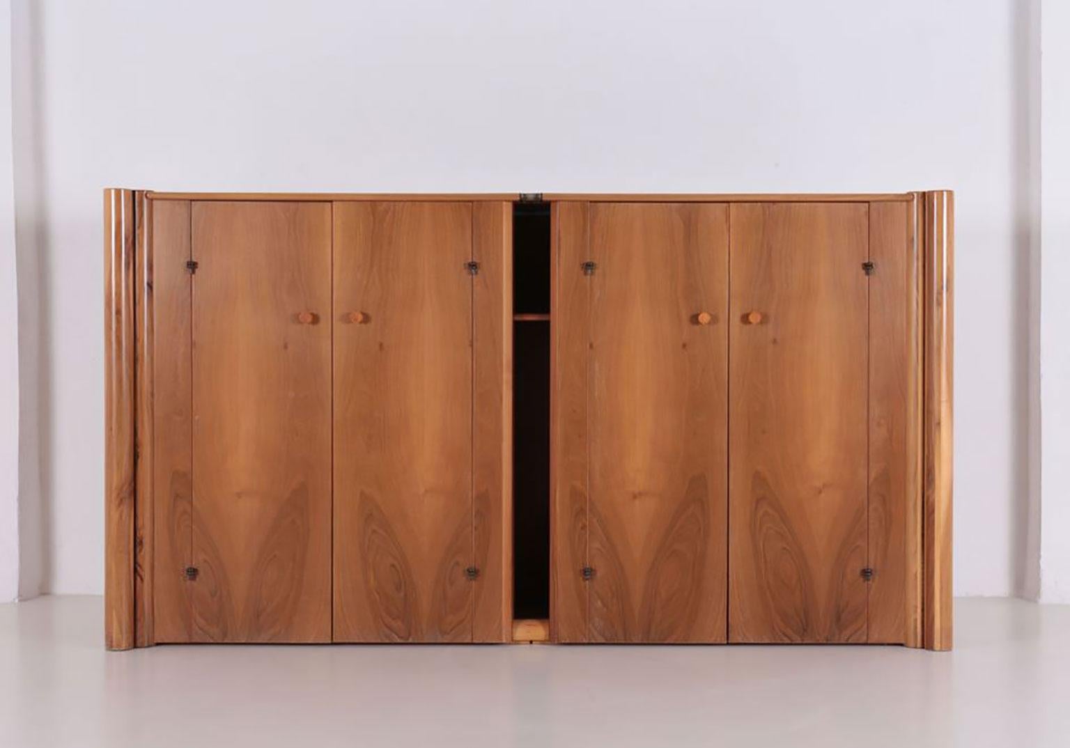 Scuderia sideboard, designed by Carlo Scarpa in 1977 for Bernini. Italian walnut horizontal four doors sideboard with double cylindrical elements on either side.
