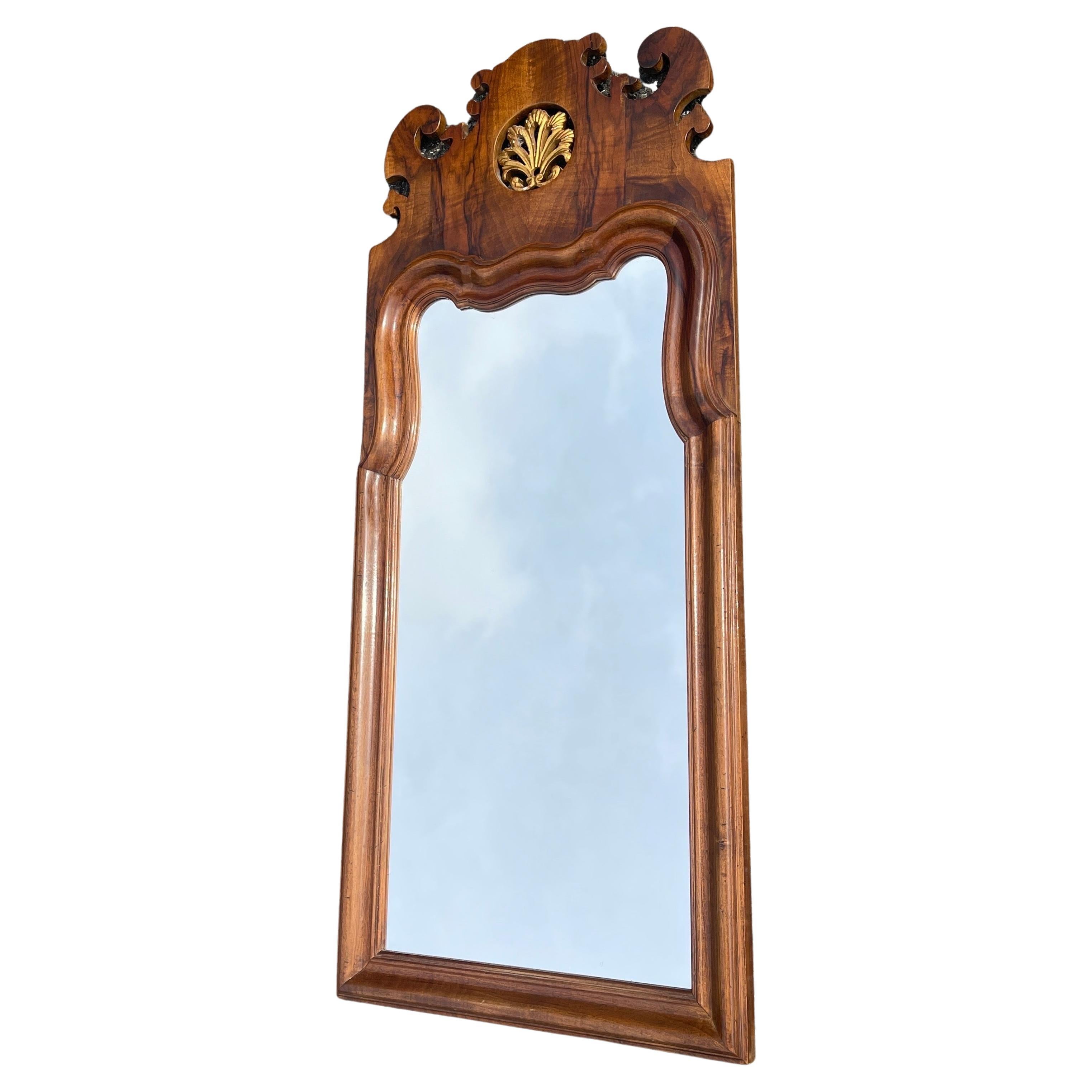 1960's Walnut Veneer Rococo Style Mirror, Italy 

A Rococo-style mirror from the 1960’s. Rococo is a highly ornamental and decorative style characterized by intricate details, asymmetrical forms, and natural motifs. It was prominent in the mid to