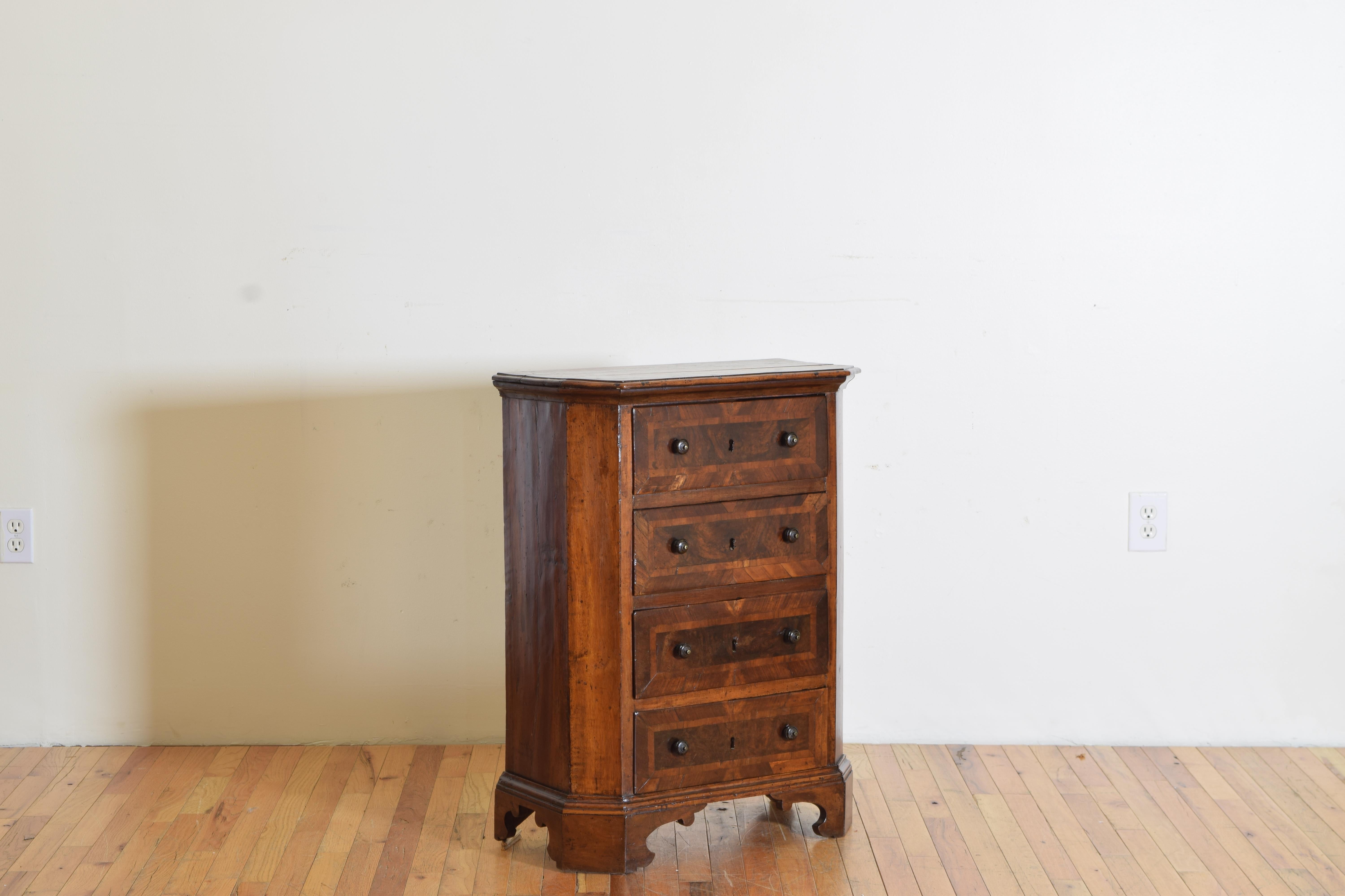 Norhtern Italian, likely Veneto but possibly Lombardia, the rectangular top with canted front corners, thus scantonata, above a conforming case housing 4 drawers with lacquered brass pulls, the drawer fronts in angled veneers and rectangular banded