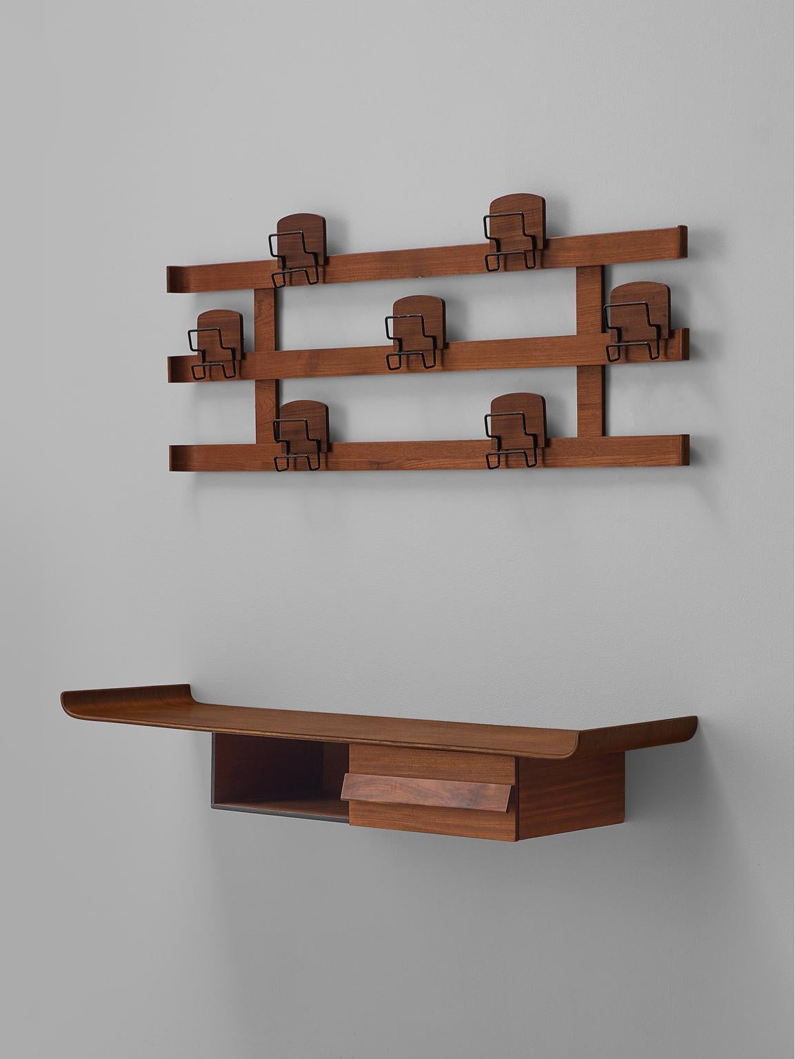 Vestibule set including shelf coat rack, walnut and steel, Italy, 1950s

This elegant set is an ensemble of a coat rack, shelf and bench. The set is executed in warm walnut and features many fine details such as the upward bent edges of the edges