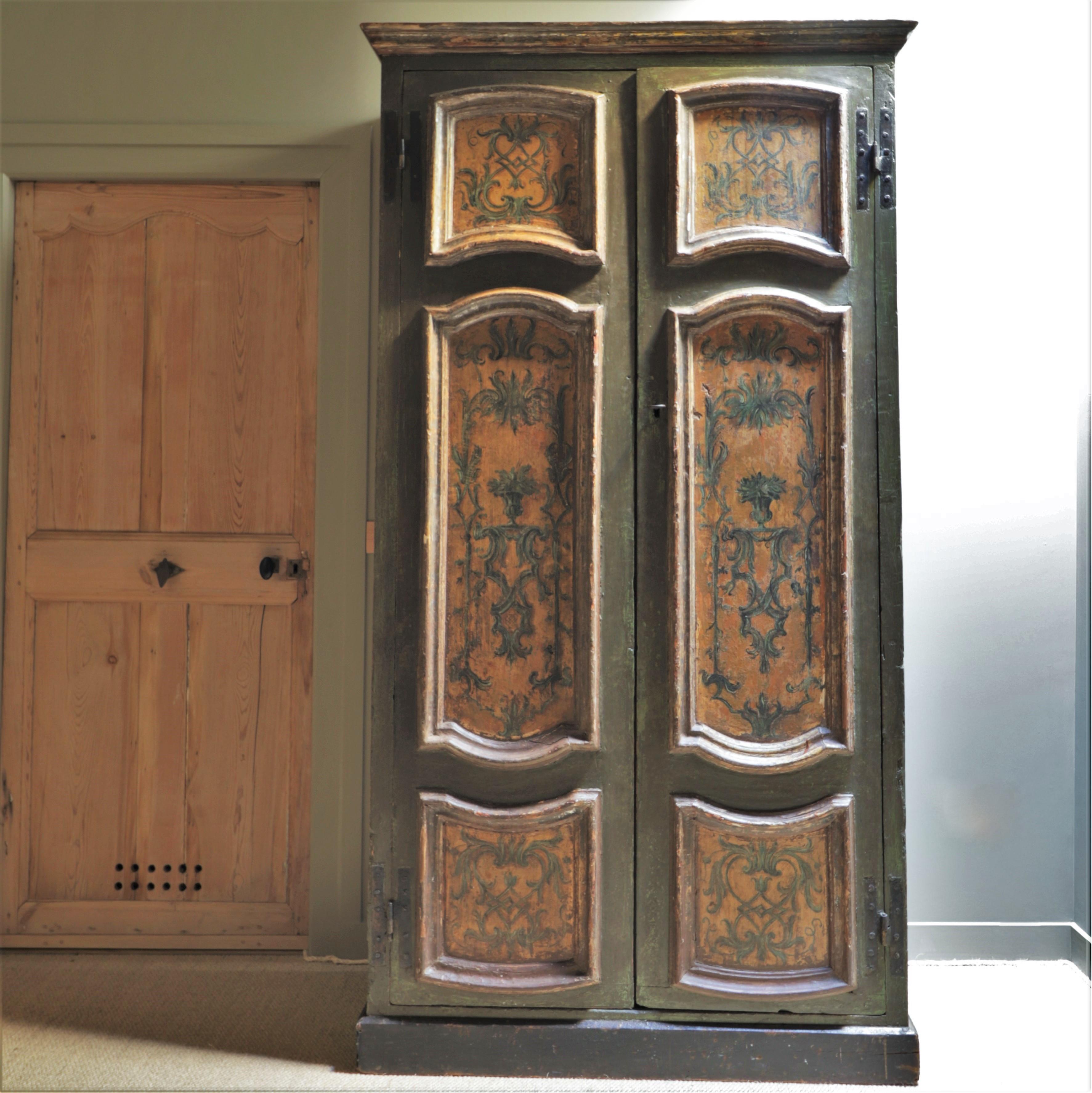 This Italian wardrobe dates from the 18th century. It is adorned with floral and vegetal patterns and painted in shades of green and ochre.