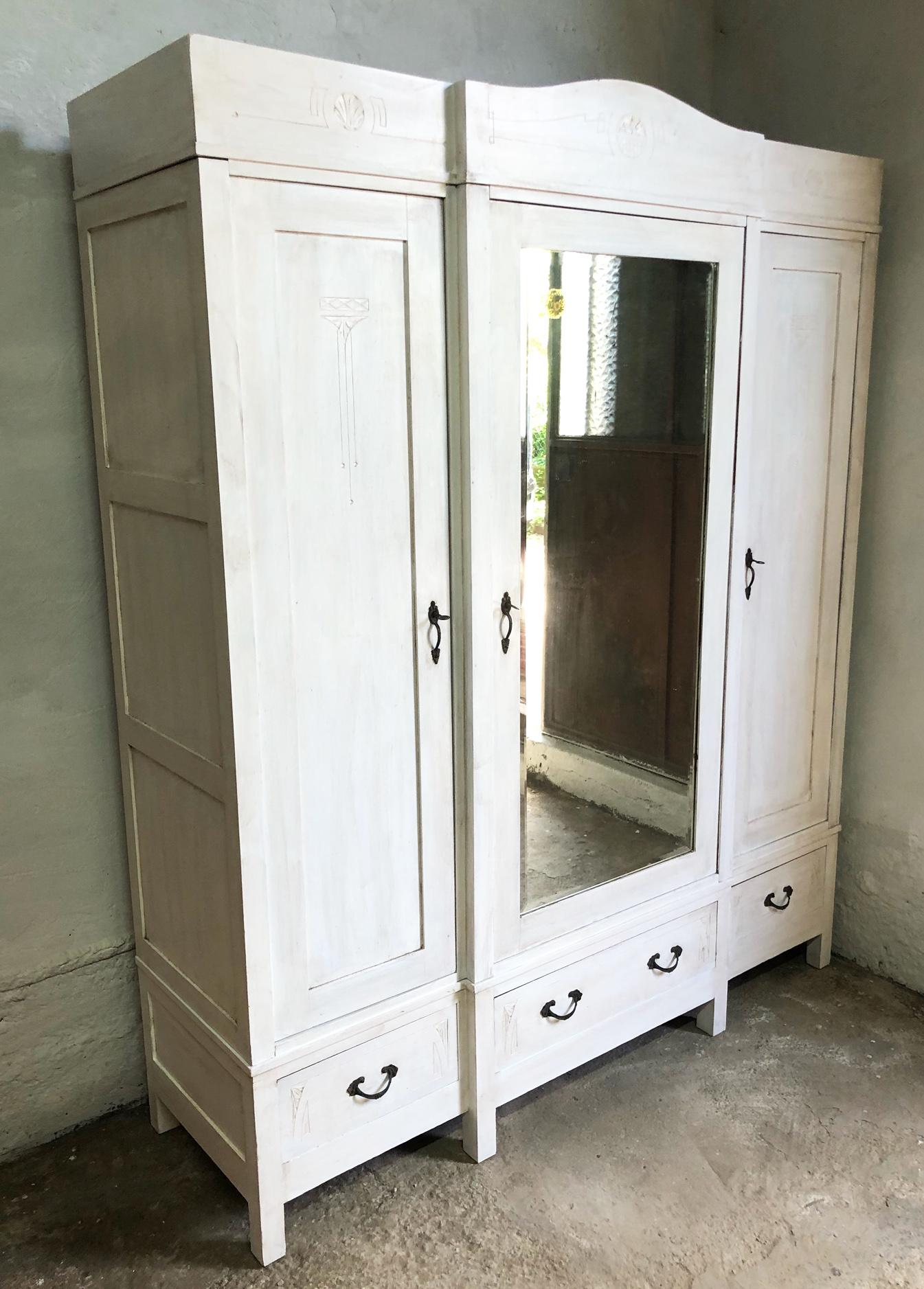 Italian wardrobe about from 1930, original, with three doors, patinated shabby white color.
The central door has the mirror on the outside.
 It can be completely disassembled and can be easily reassembled in 15 minutes.
The wardrobe has been