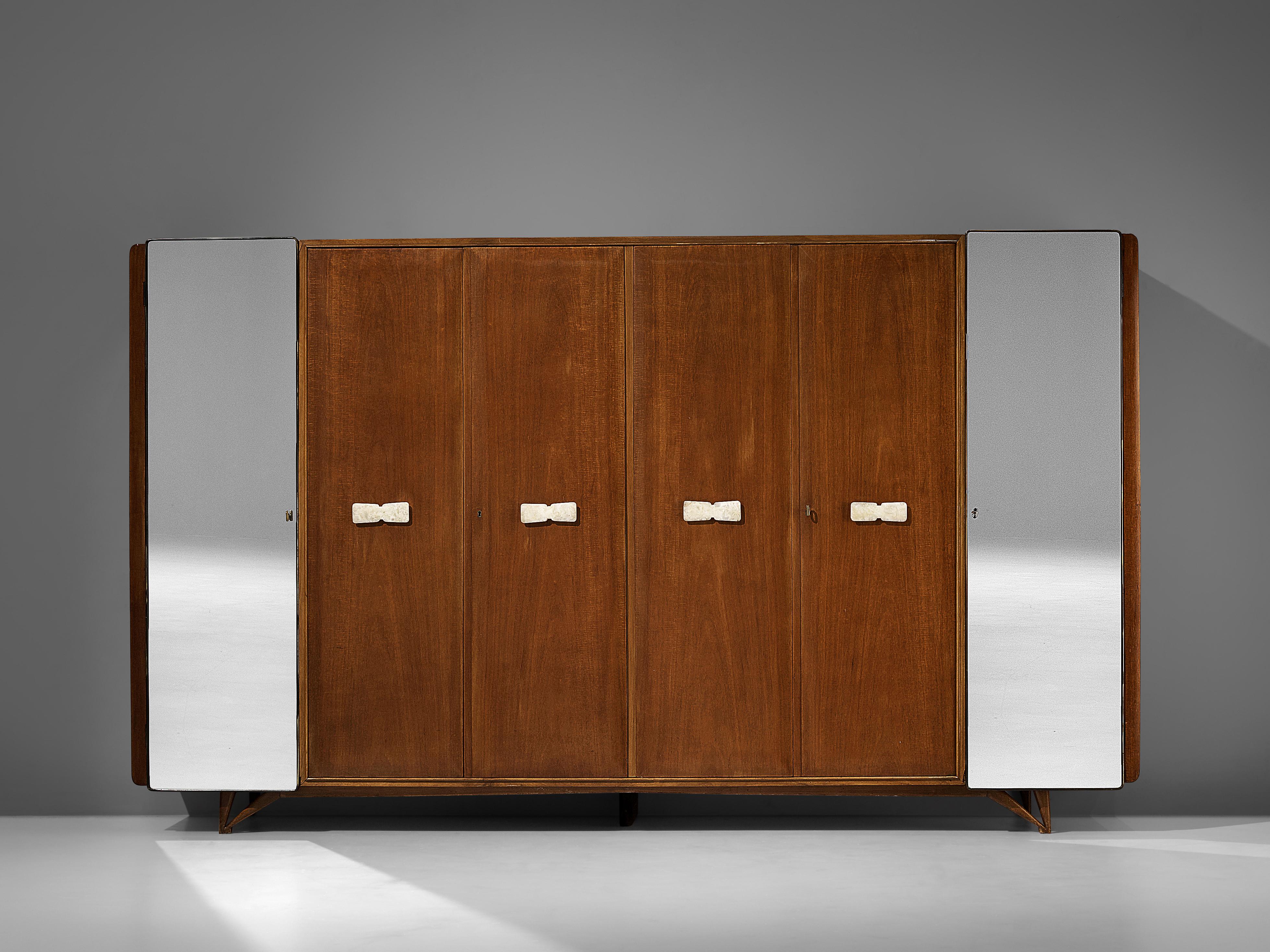 Wardrobe, curly mahogany, maple, mirrored glass, brass, alabaster, Italy, 1960s

With its six doors this Italian armoire has an impressive size. Two mirrored doors flank the sides, while the four inner doors showcase luxurious mahogany veneer. The