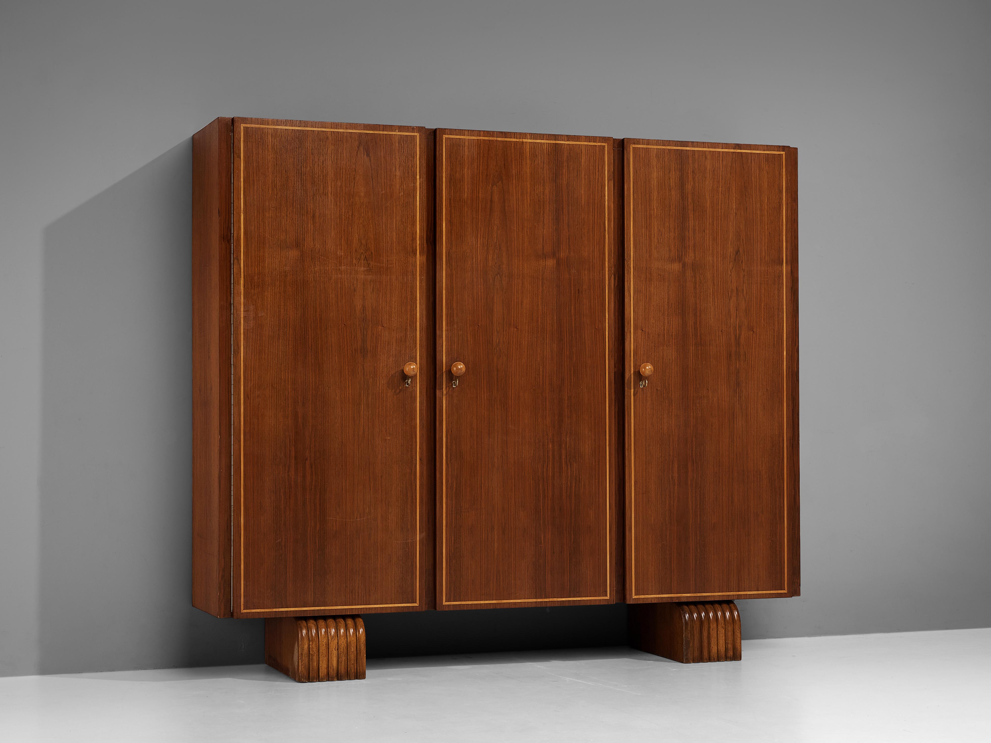 Italian wardrobe, walnut, maple, Italy, 1940s 

This elegant wardrobe executed in walnut and maple is designed in the manner of the widely celebrated Italian designer Gio Ponti (1891-1979). With three doors, and a middle compartment containing