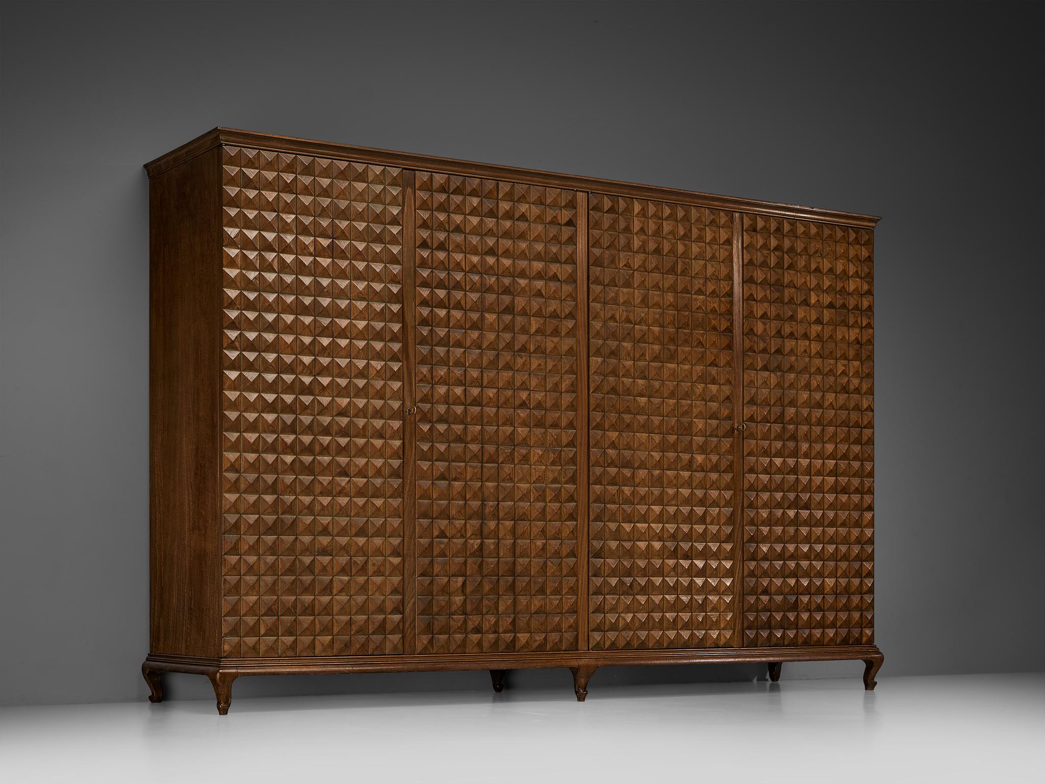 Wardrobe or high board, chestnut, Italy, 1950s

This grandiose Italian wardrobe exudes a commanding presence and boasts exquisite characteristics. When taking a moment to take in the beauty that this piece showcases, quickly the inspiring woodwork