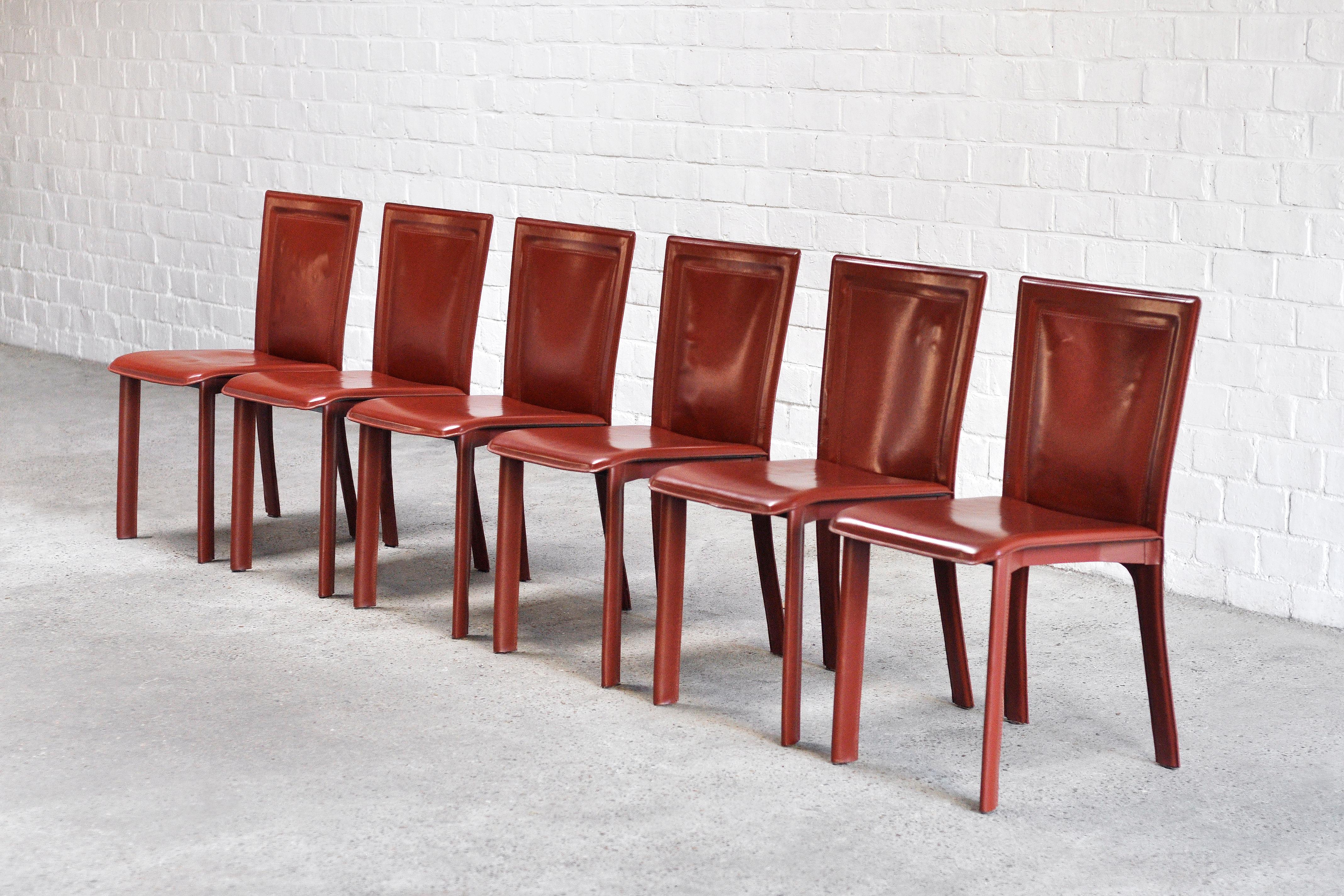 A beautiful set of six Italian dining chairs in a warm red leather, 1980s. These chairs are very much in the style of Mario Bellini or Matteo Grassi, but are unbranded. They show a high level of manufacturing with a very sturdy structure and quality