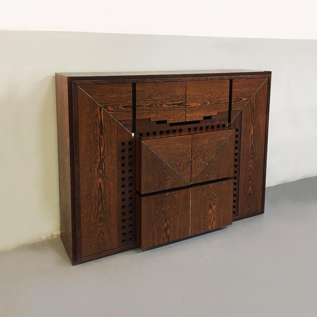 Italian Wengé cabinet Micene by F. Meccani for Meccani Arredamenti, 1978.
solid wengé cabinet Micene with eight doors and eight shelves, one drawer, inlaid with mother of pearl.

Very good condition

Measures: 150 x 192 x 57 cm.